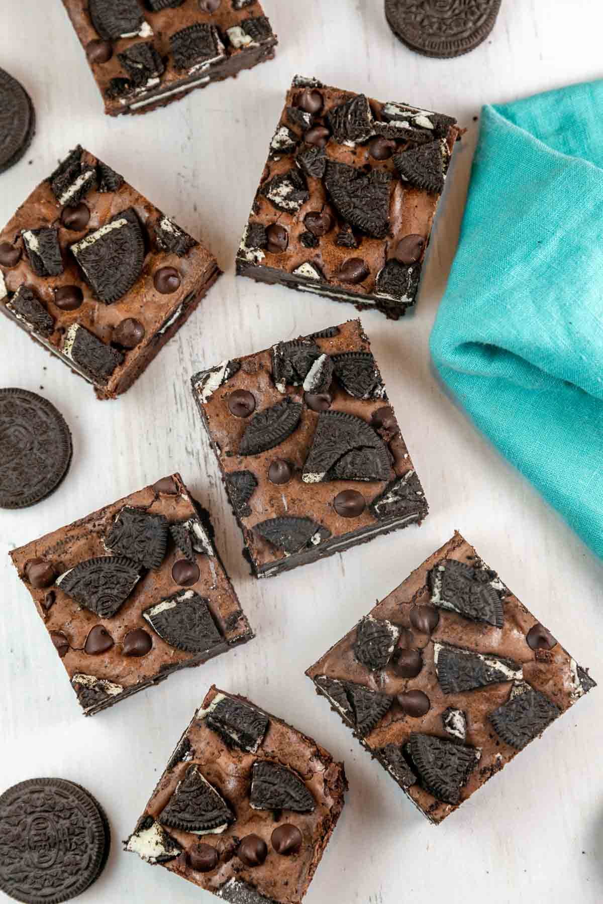 large squares of oreo stuffed brownies with chopped oreos on top