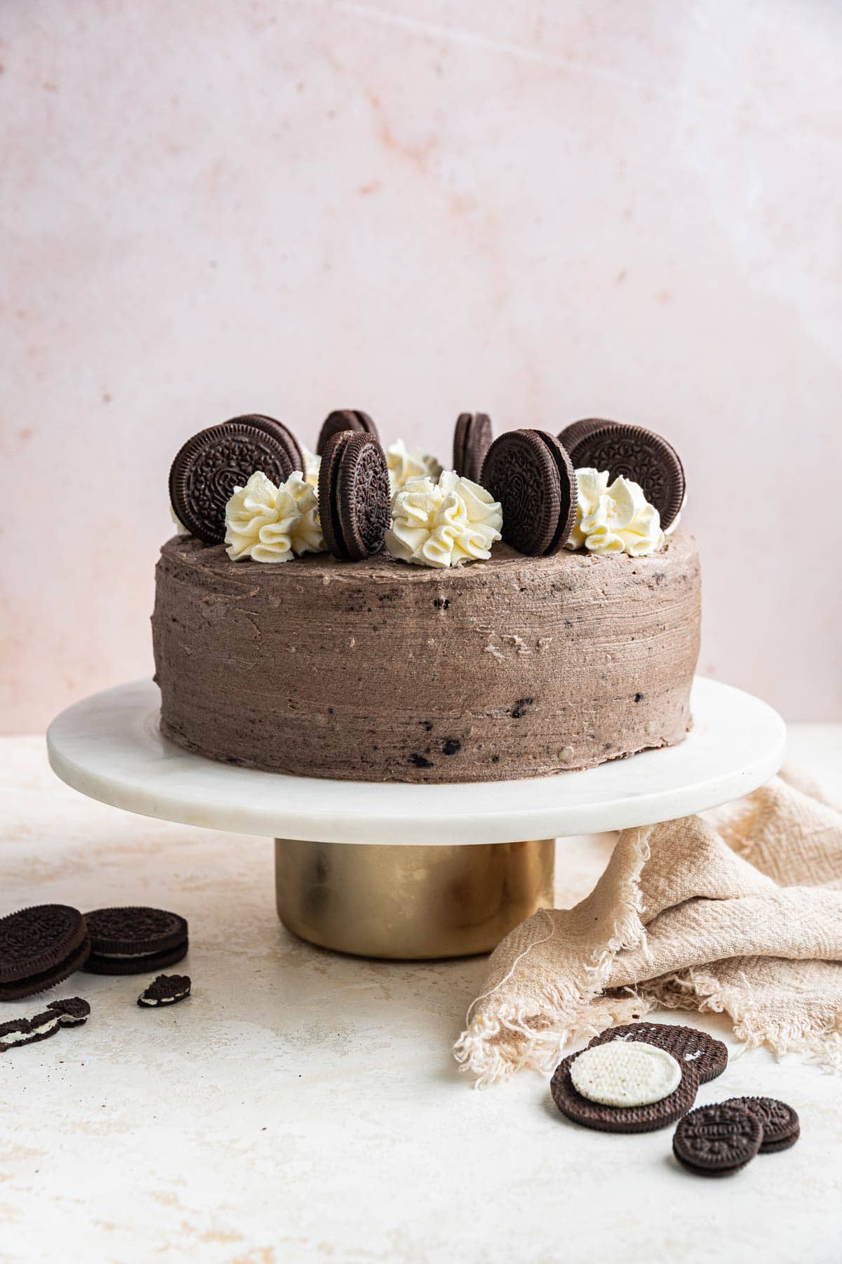 cake covered with oreo frosting on cake stand