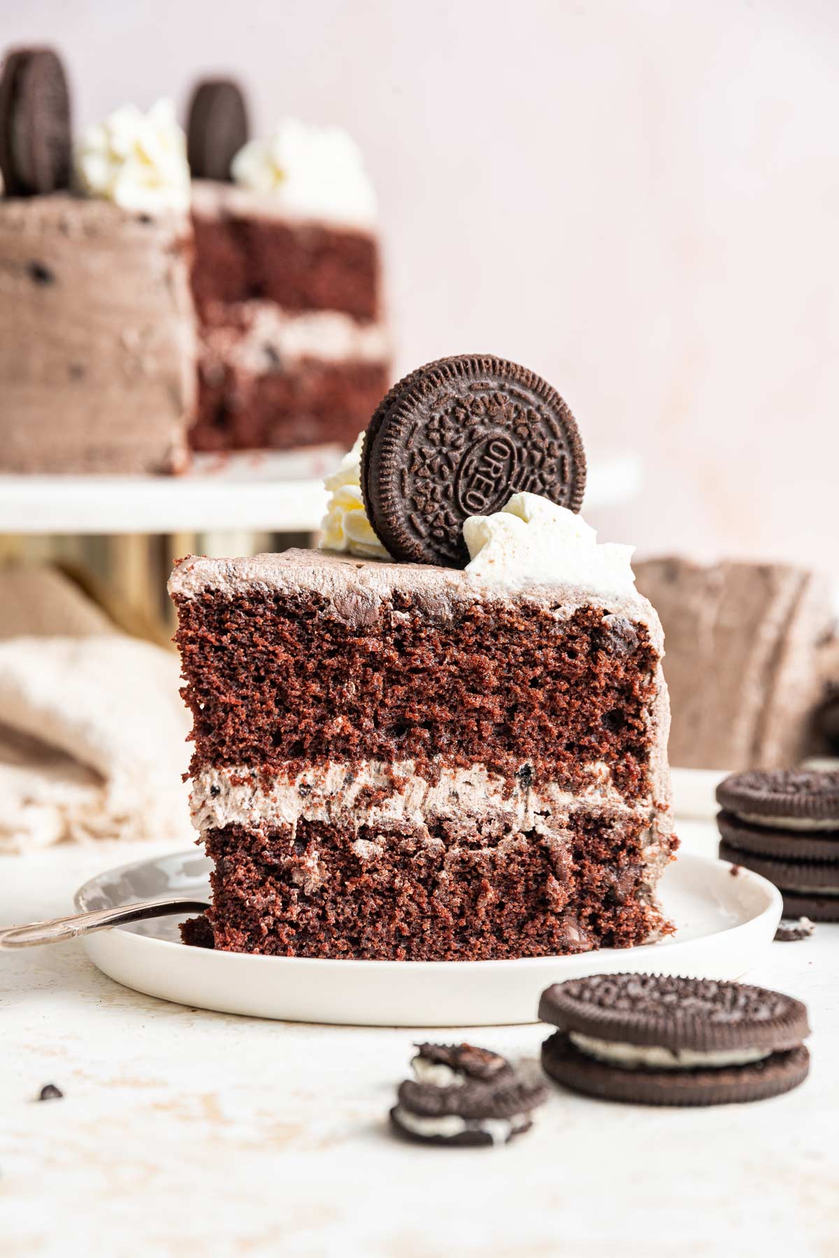 slice of two layer chocolate oreo cake on a dessert plate