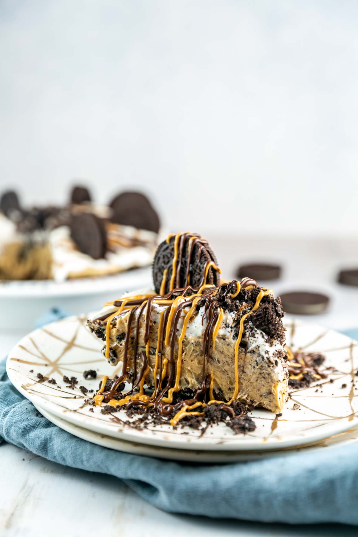 slice of pie covered in chocolate and peanut butter drizzles