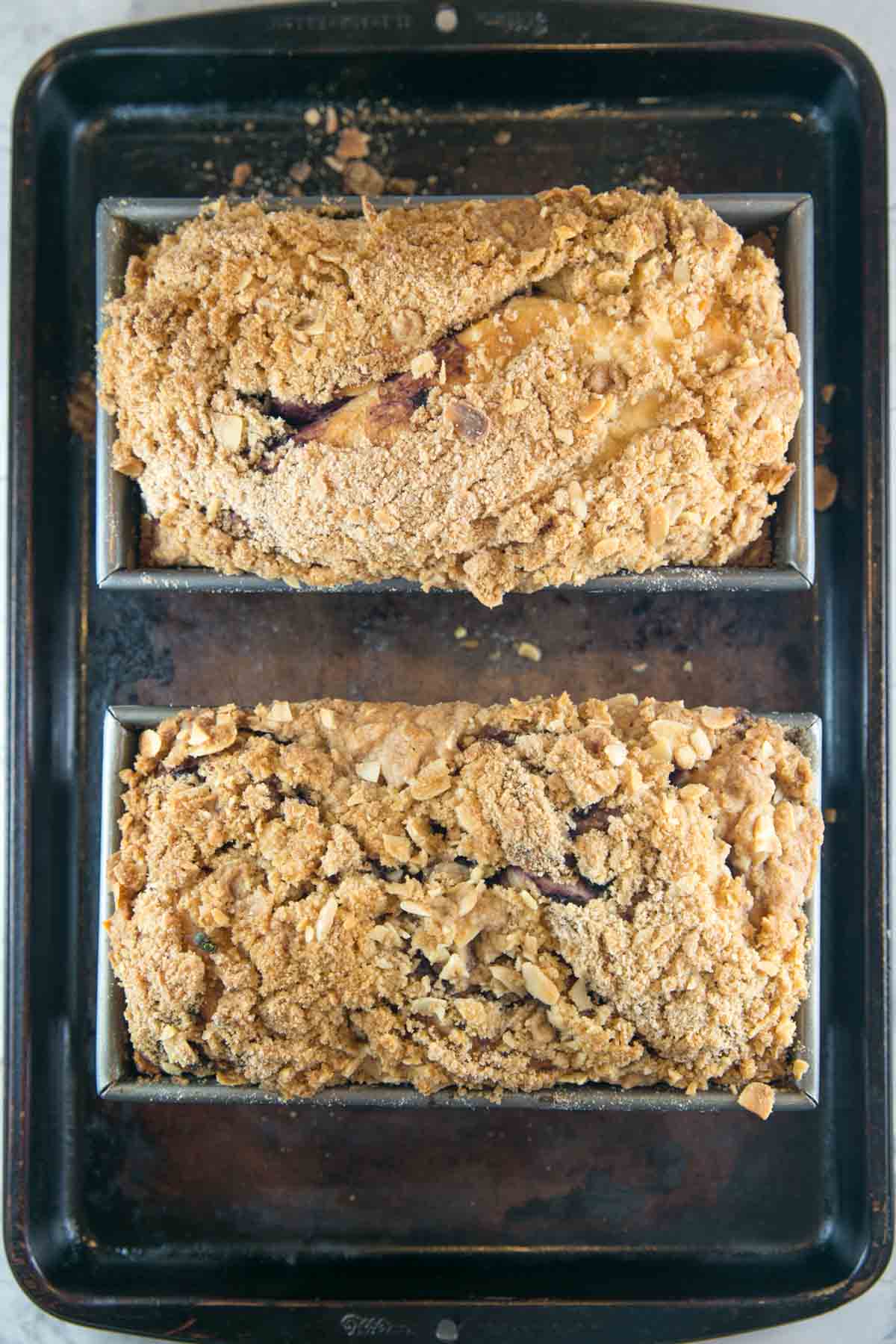 two loaves of babka covered in crunchy golden almond streusel