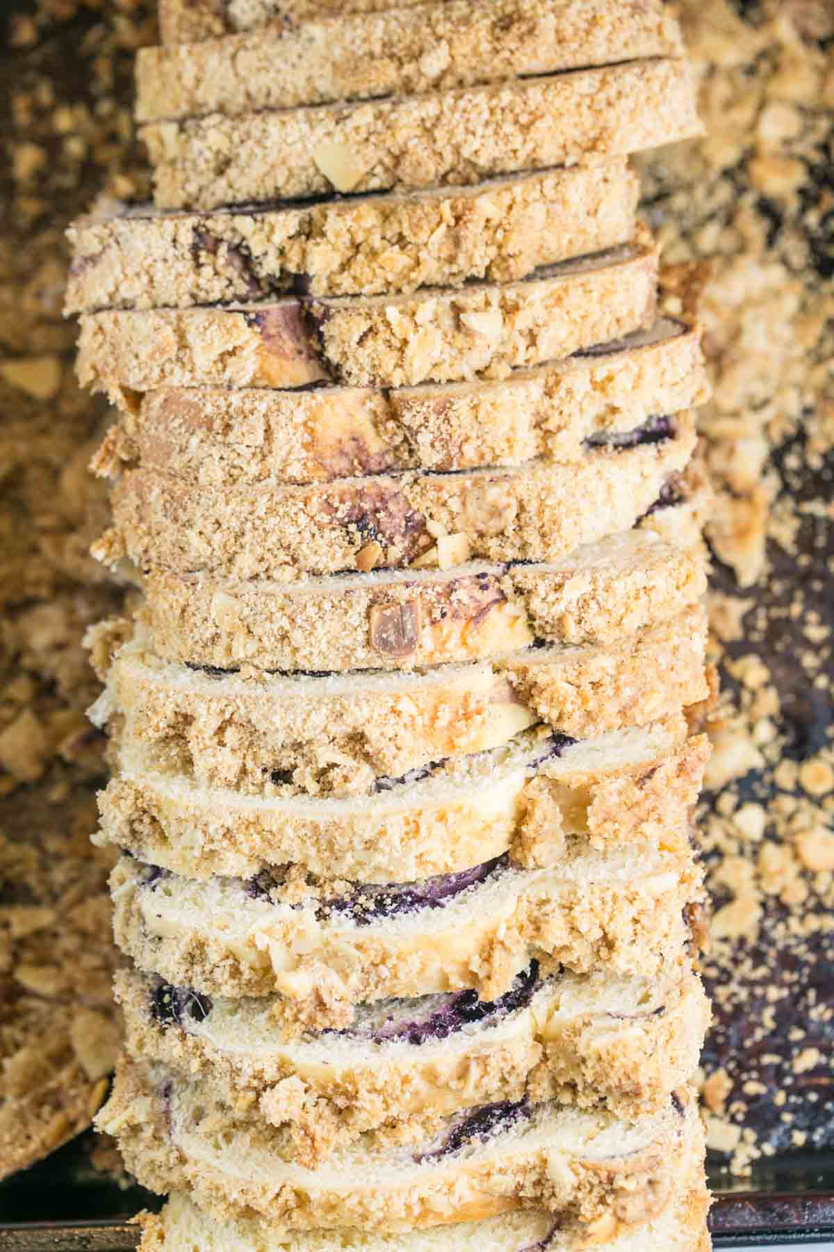 thinly sliced loaf of blueberry babka covered in almond streusel