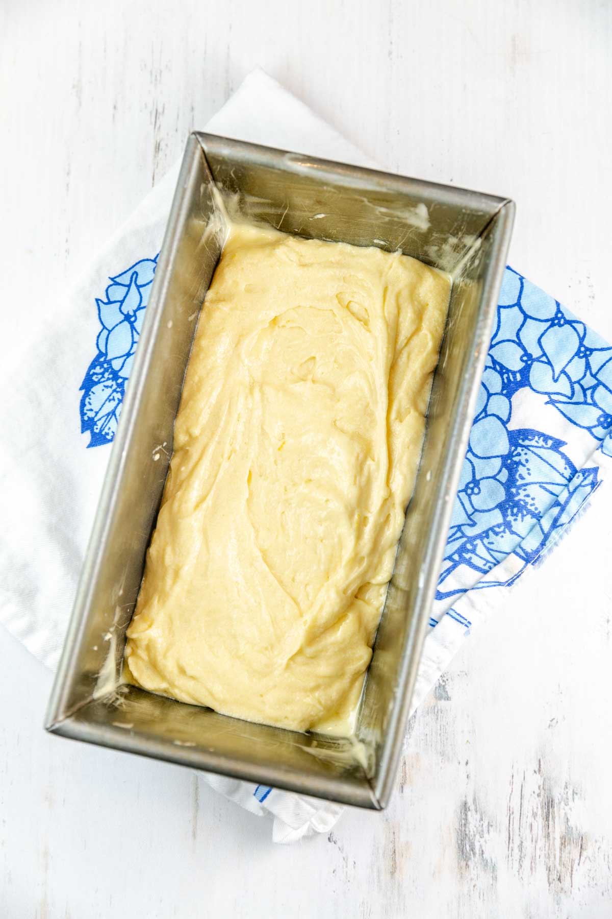 a layer of lemon pound cake batter in a loaf pan
