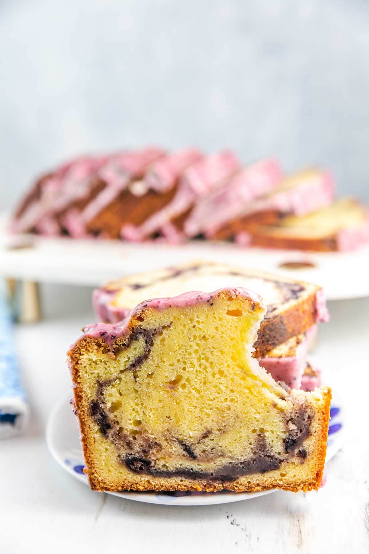 Slice of pound cake with a bite taken out of it with more slices in the background. 