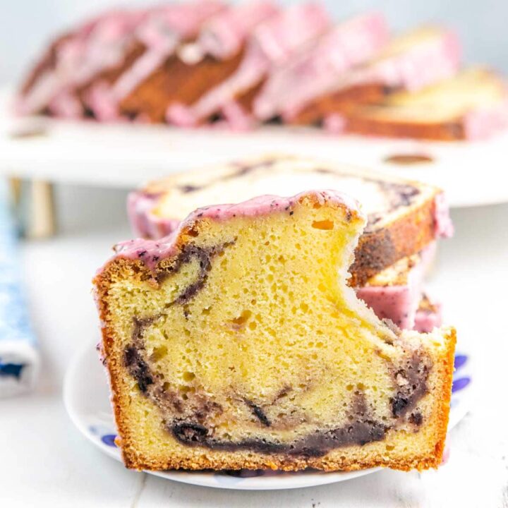 slice of lemon pound cake with blueberry swirl on a dessert plate