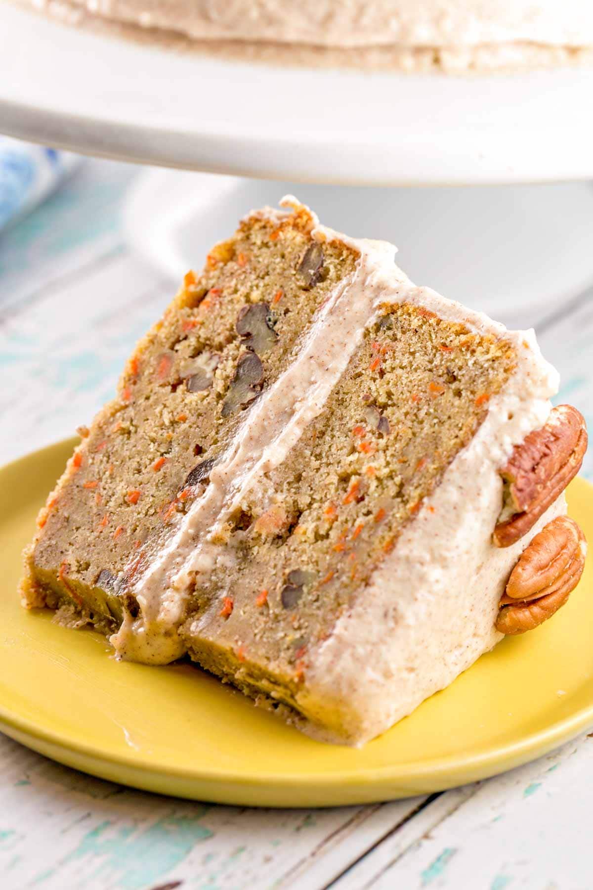 A single large slice of carrot cake covered with lemon cinnamon cream cheese frosting.