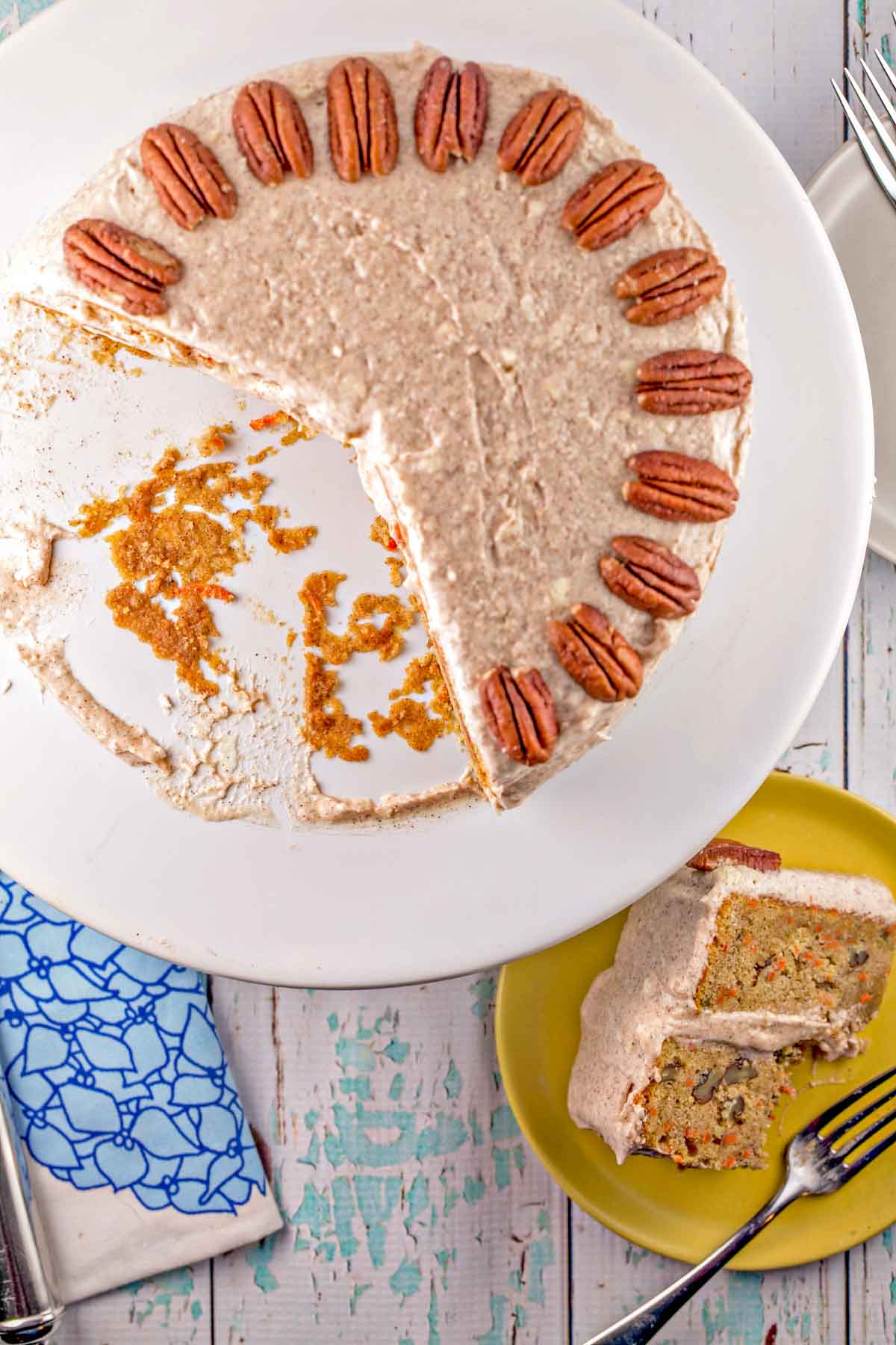 overhead view of a carrot cake with two large slices removed