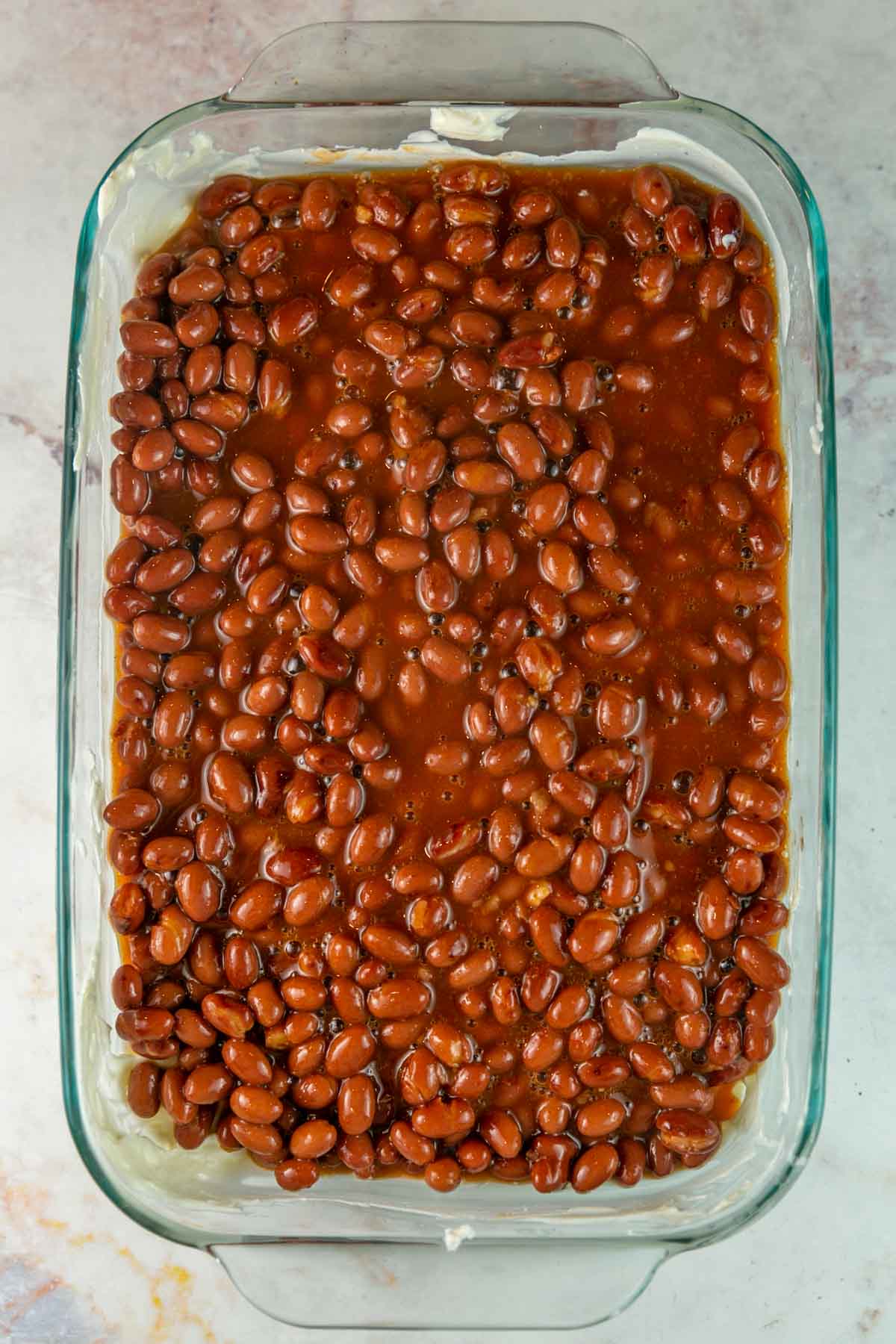 baking dish with a layer of canned chili beans