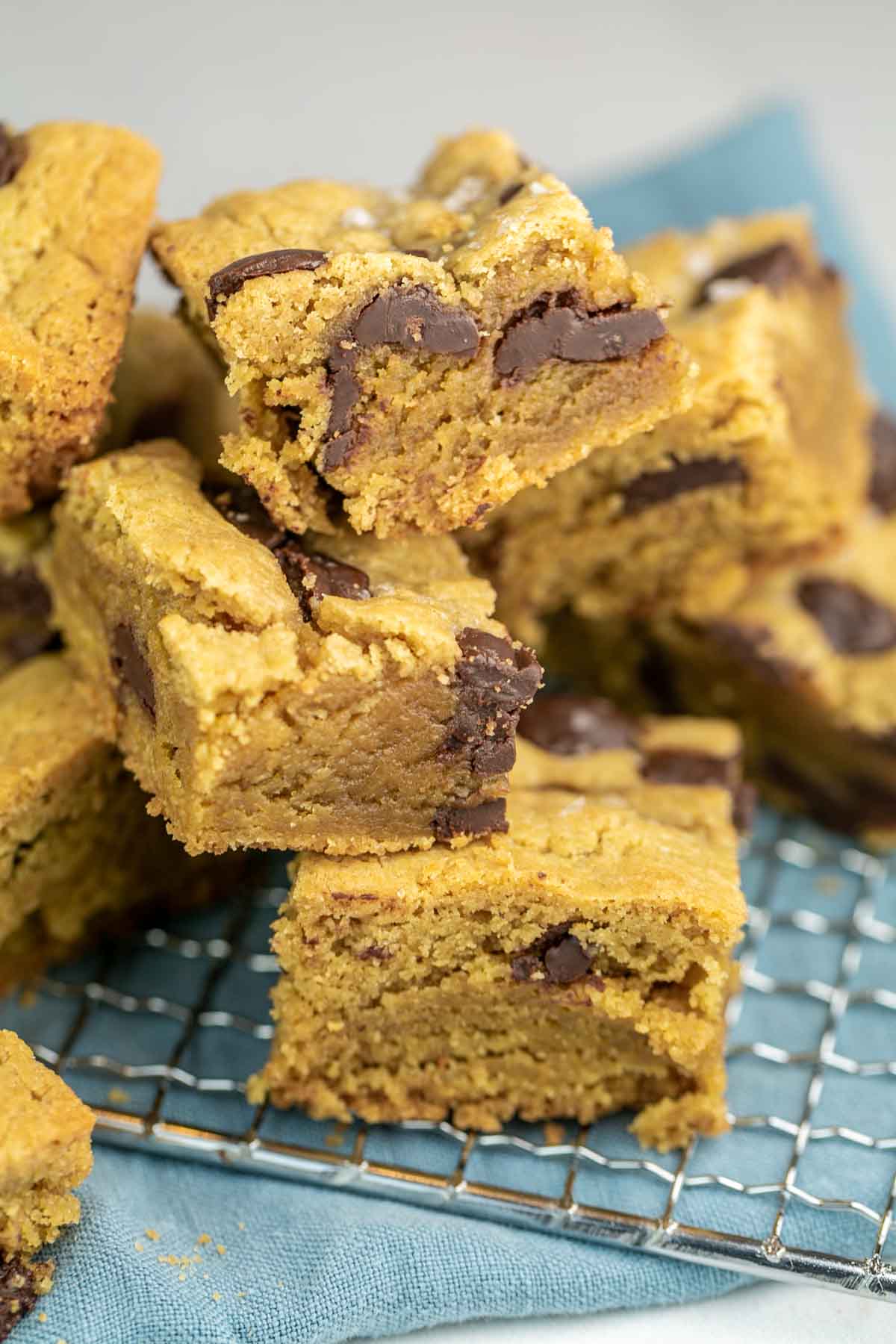 a pile of tahini blondies showing the soft, gooey interior