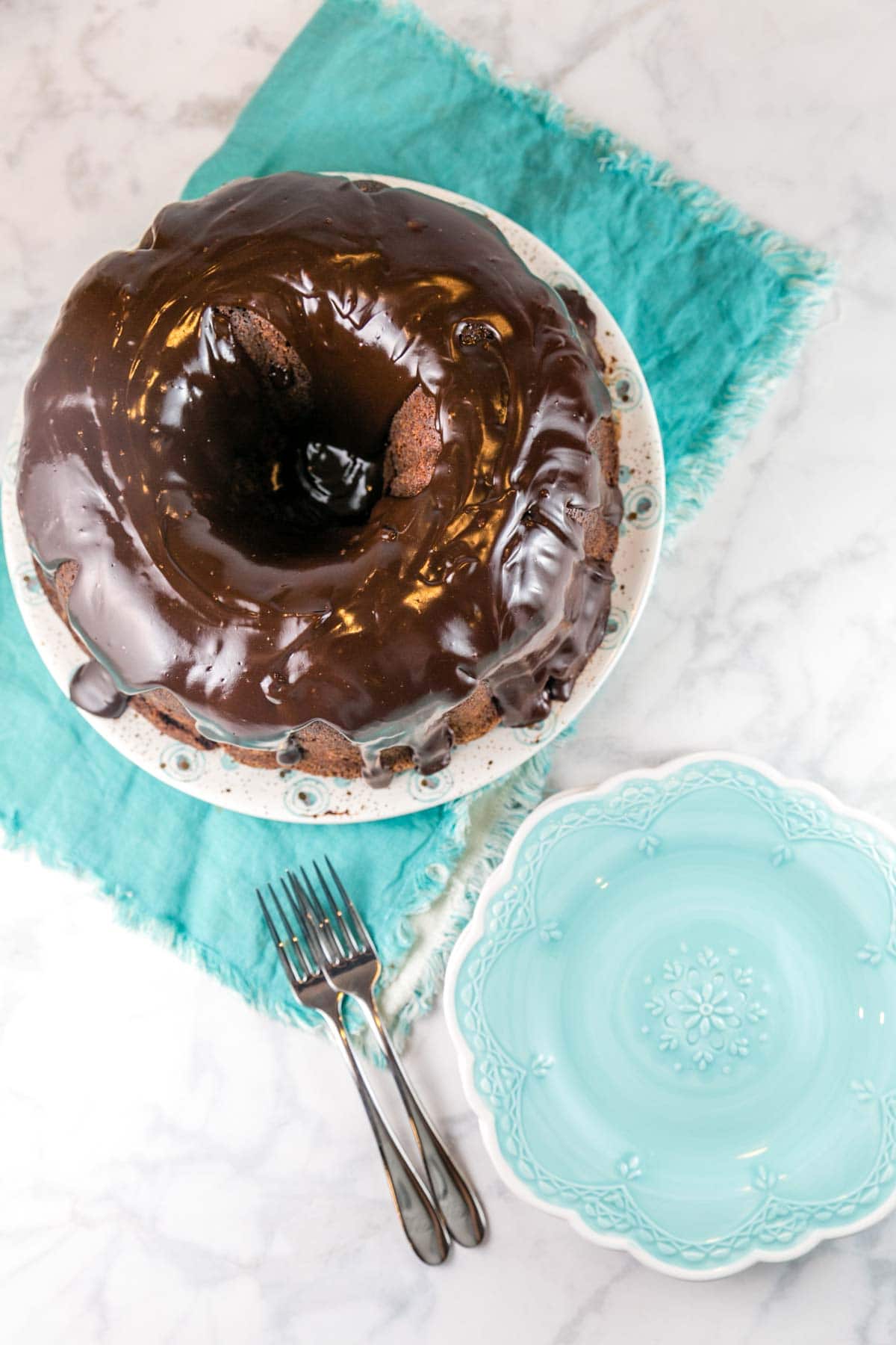 round pound cake covered in a layer of chocolate ganache