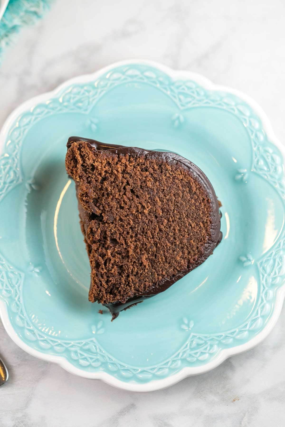 a slice of cake on a dessert plate highlighting the fine crumb of the cake