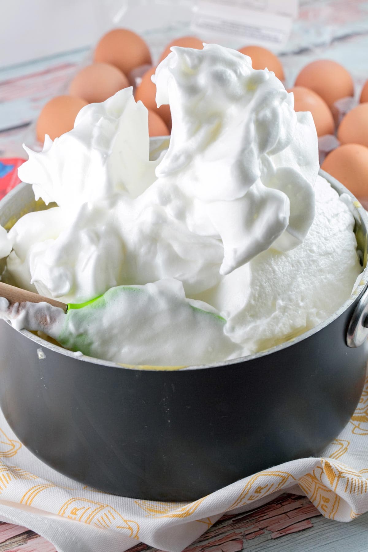 a giant pile of whipped egg whites in a saucepan 