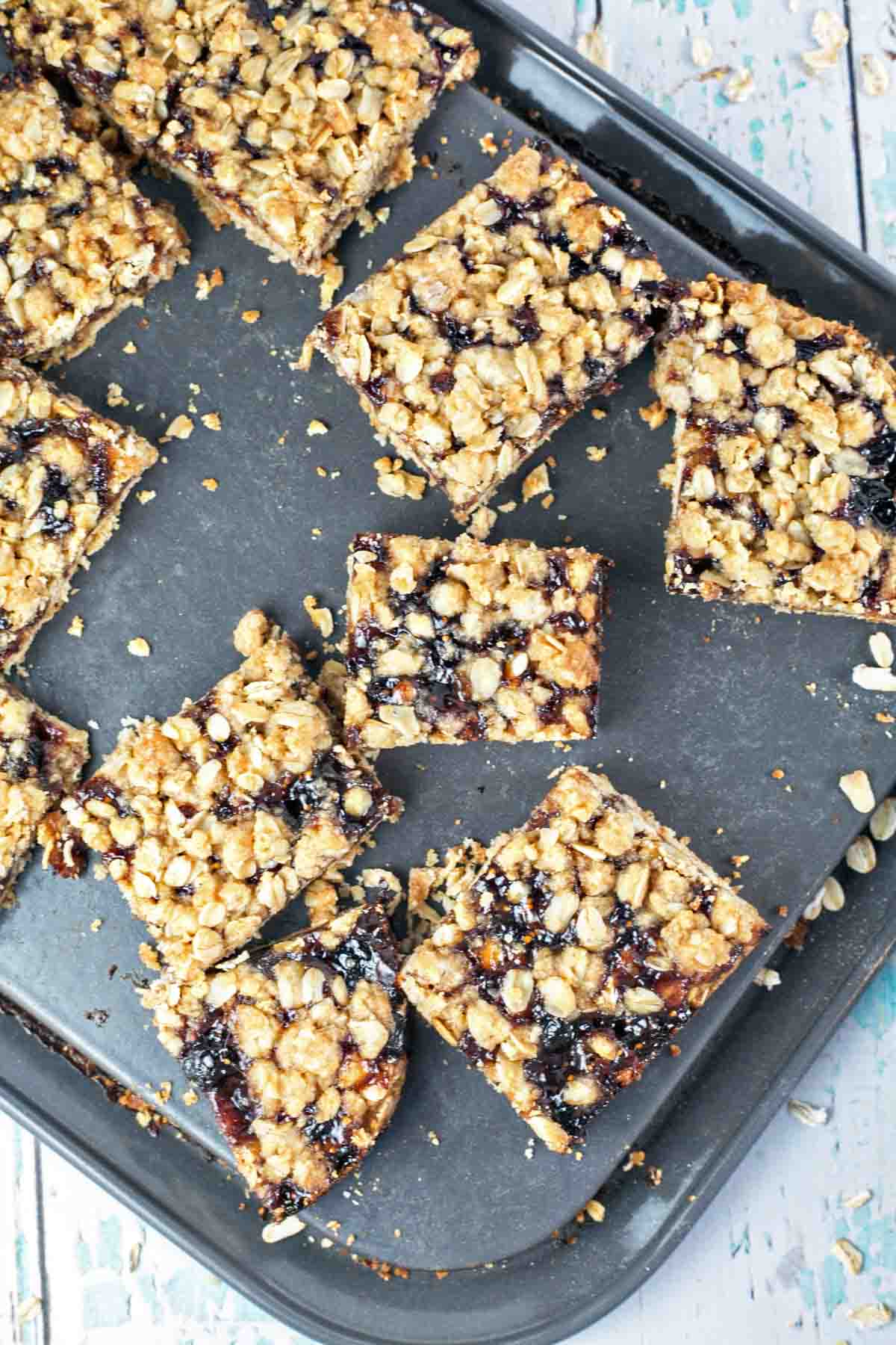 oatmeal jam bars cut and spread out in a rectangular springform pan