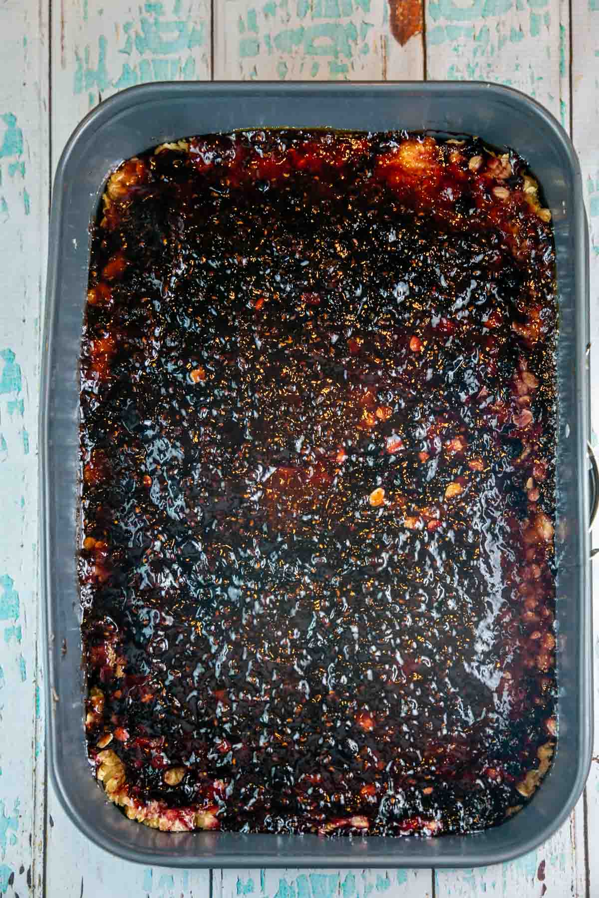 jam spread in a thin layer across an oatmeal shortbread crust