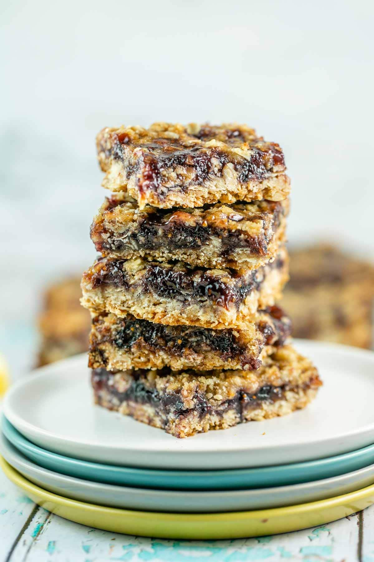 vertical stack of oatmeal jam bars on a small plate