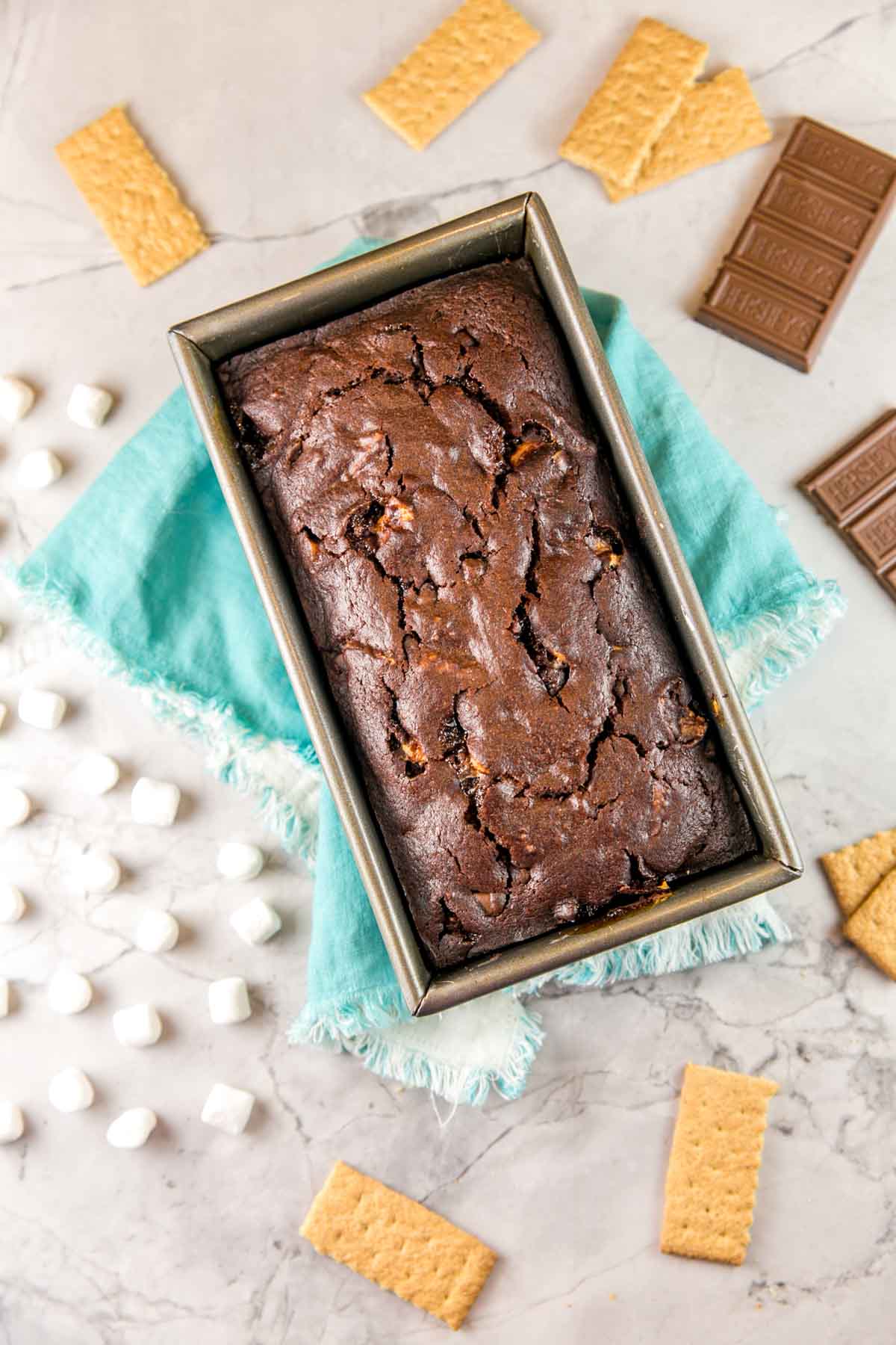 overhead view of a dark chocolate graham cracker quick bread in a loaf pan