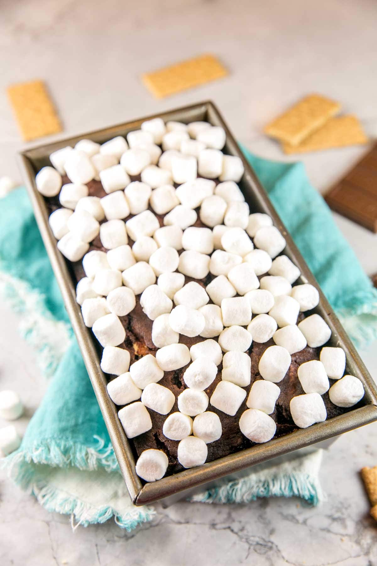 chocolate graham cracker quick bread in a loaf pan covered with miniature marshmallows