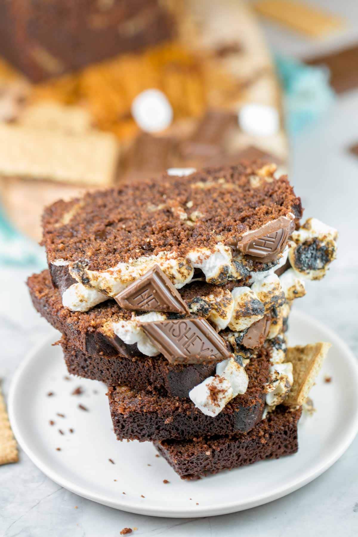 a tower of slices of chocolate s'mores quick bread stacked on a dessert plate