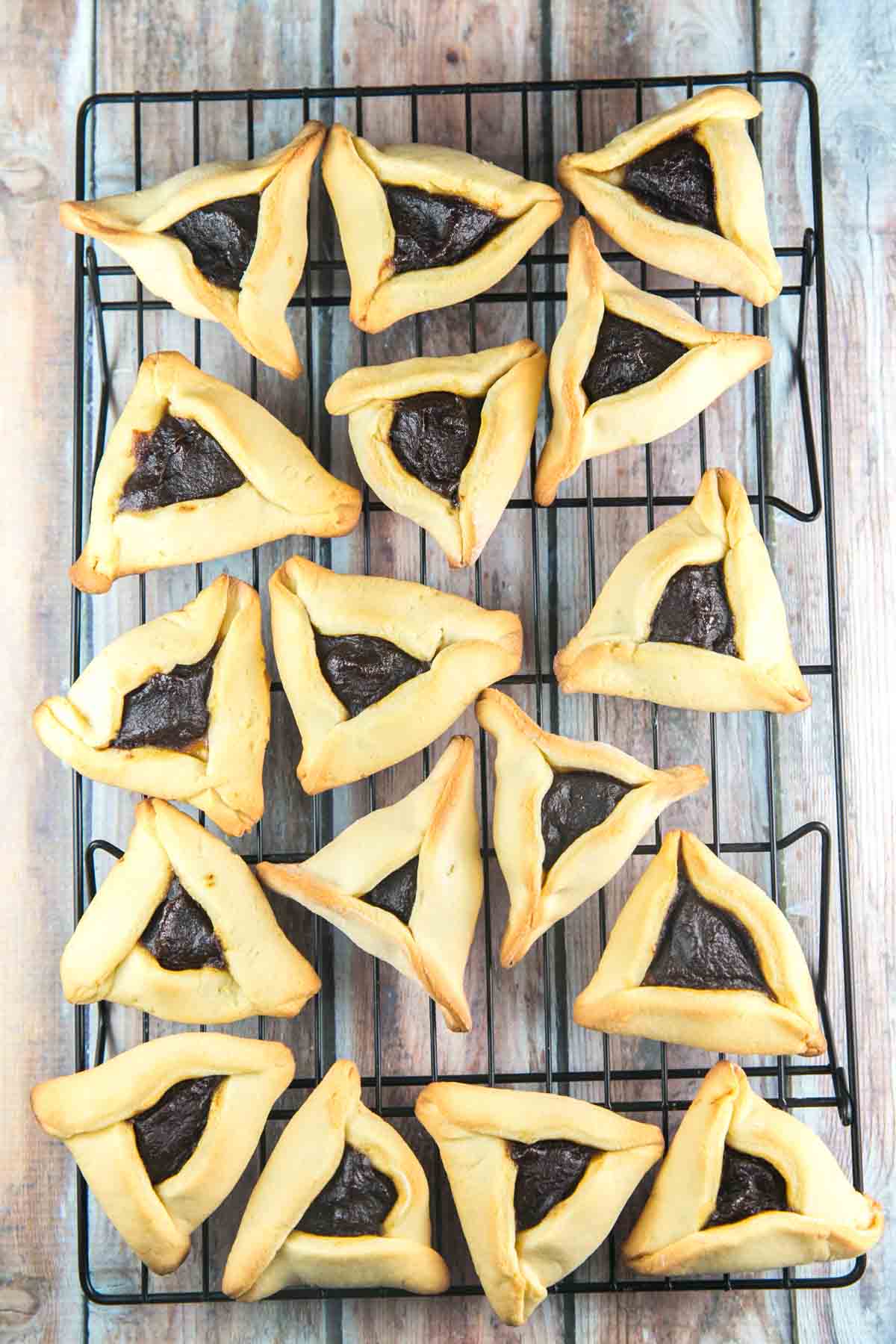 freshly baked hamantaschen arranged on a cooling rack