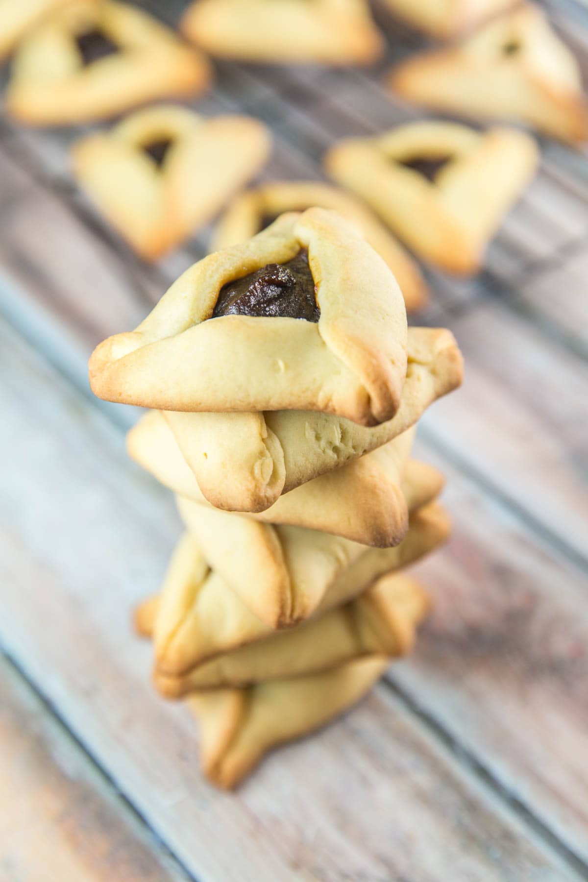 a vertical stack of hamantaschen piled on top of each other