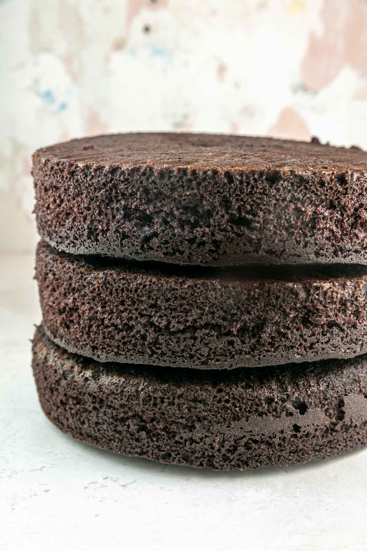 three layers of dark chocolate cake stacked on top of each other