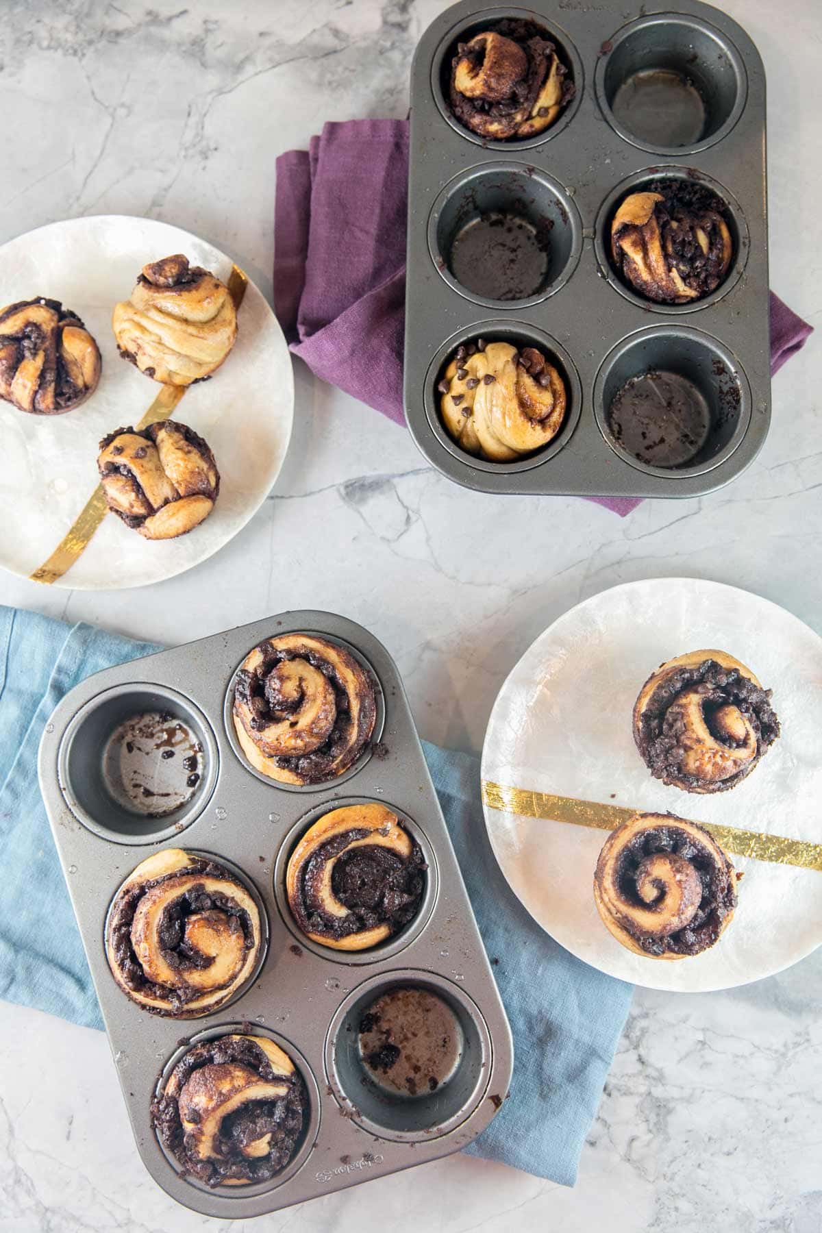 two muffin tins with chocolate babka muffins 