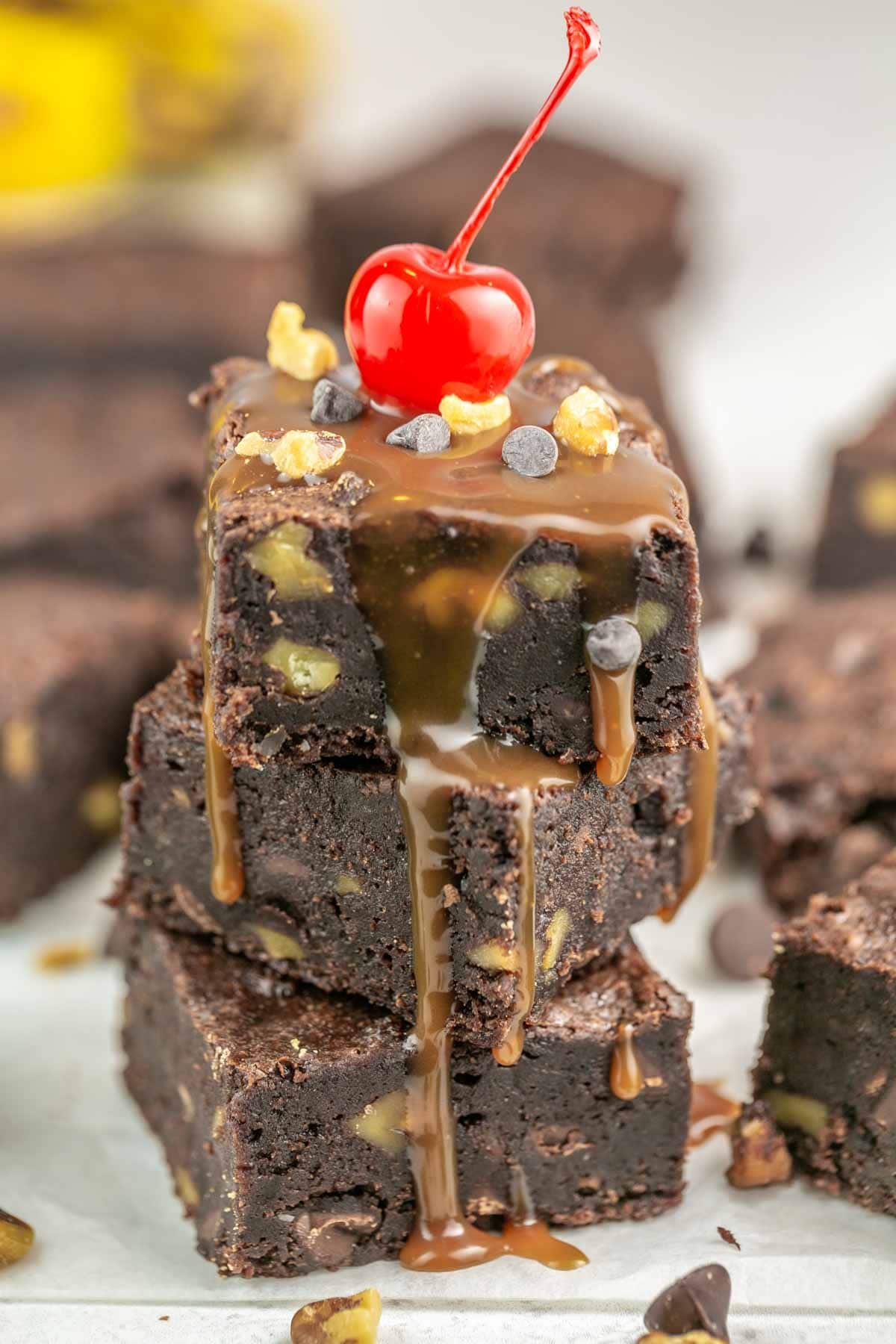 banana brownie with caramel sauce, chopped nuts, and a cherry on top