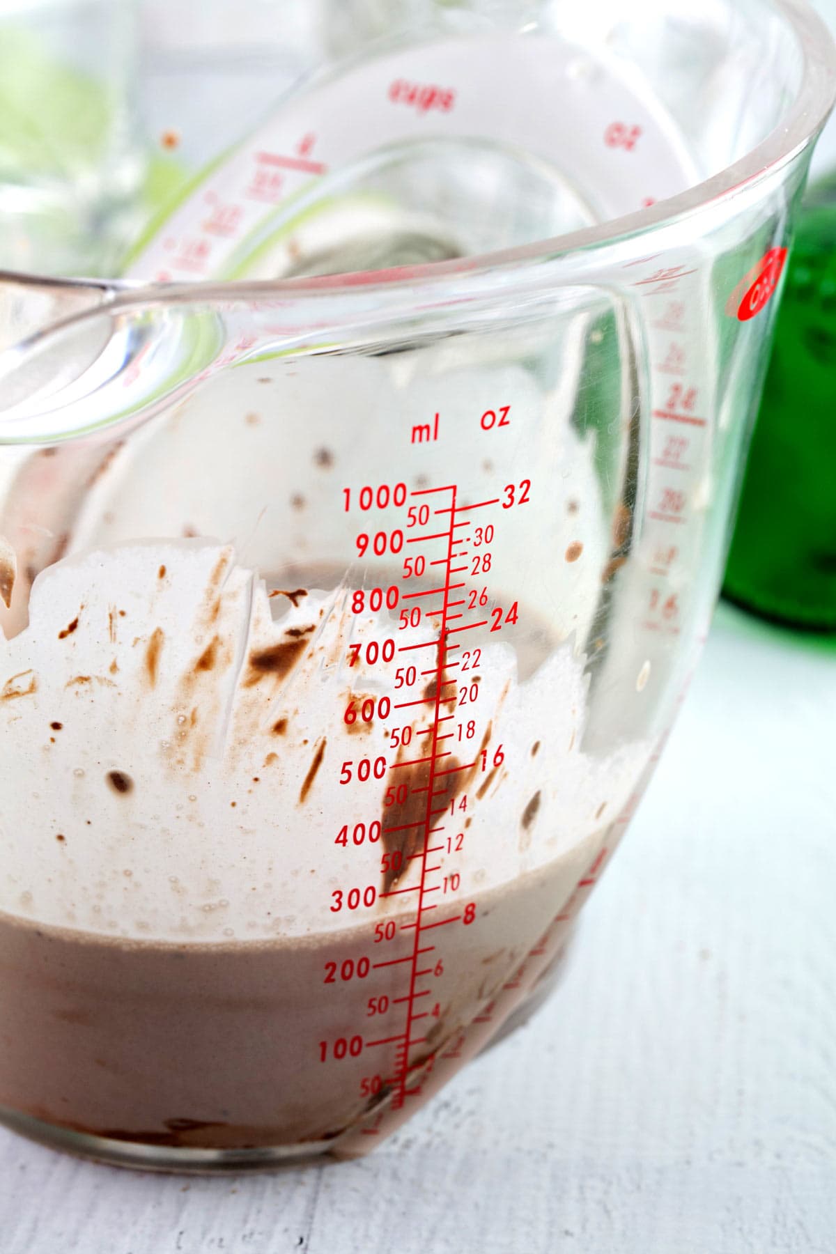 making homemade irish cream in a 4 cup liquid measuring cup.