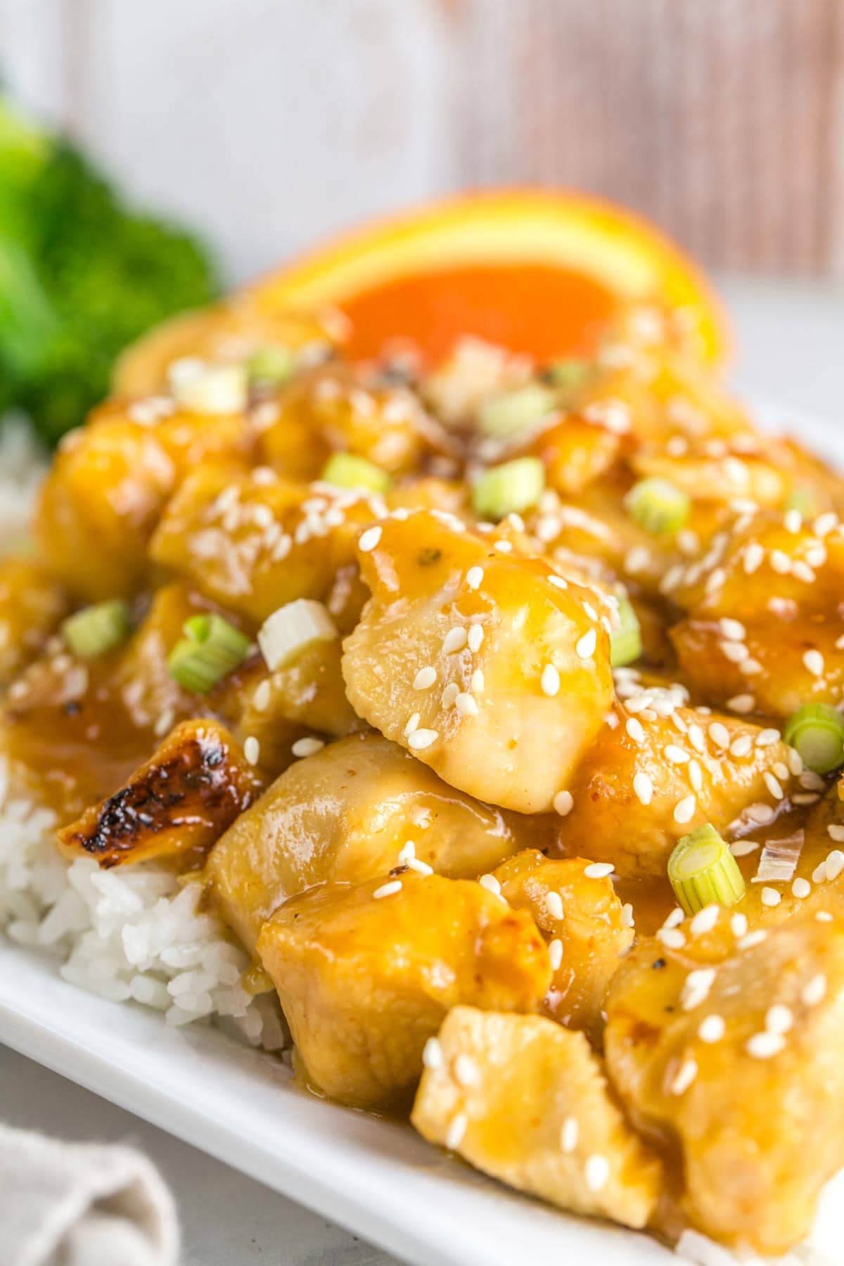 close up picture of orange chicken cooked in the instant pot covered with sauce and sesame seeds