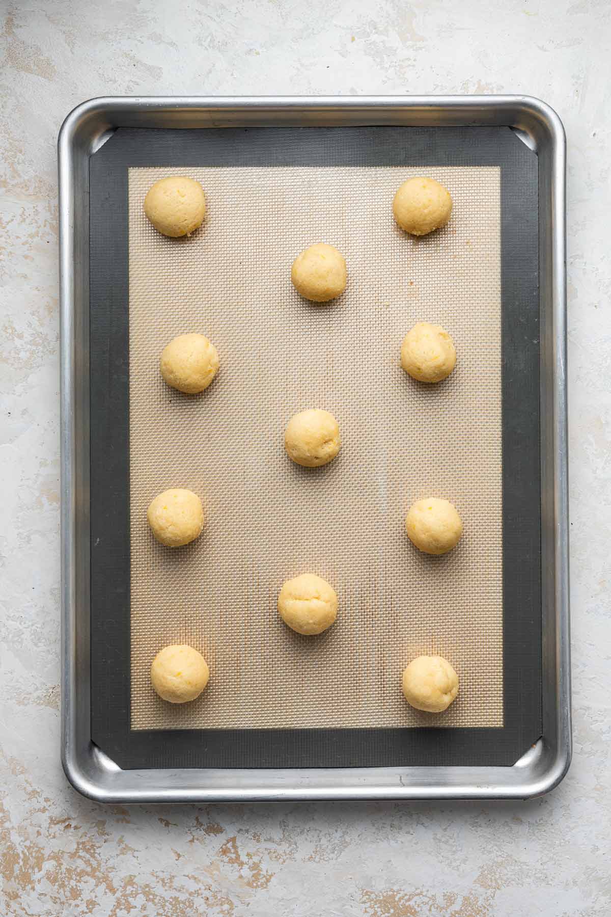 balls of cookie dough on a cookie sheet before baking