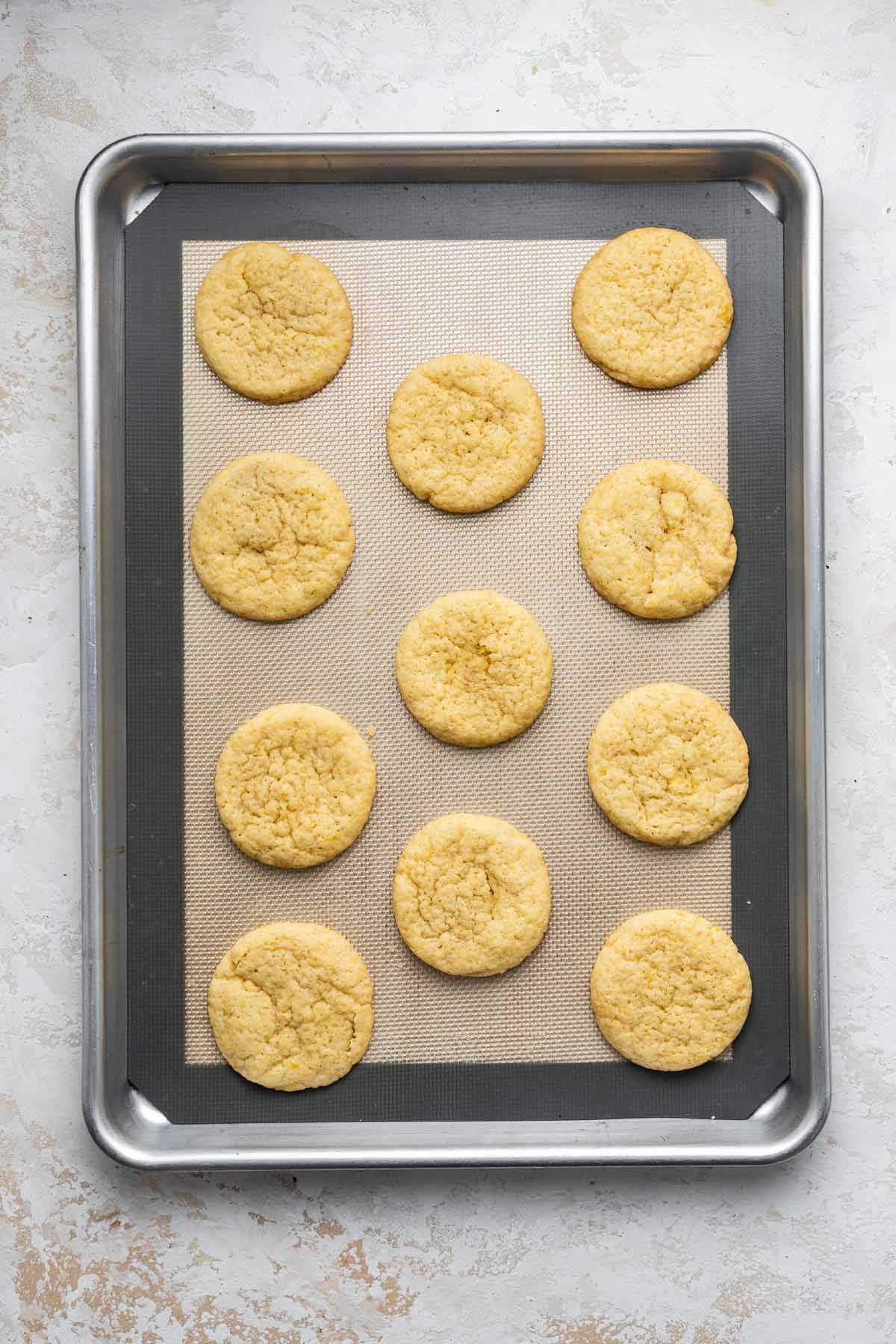 lemon sugar cookies on a baking sheet fresh out of the oven