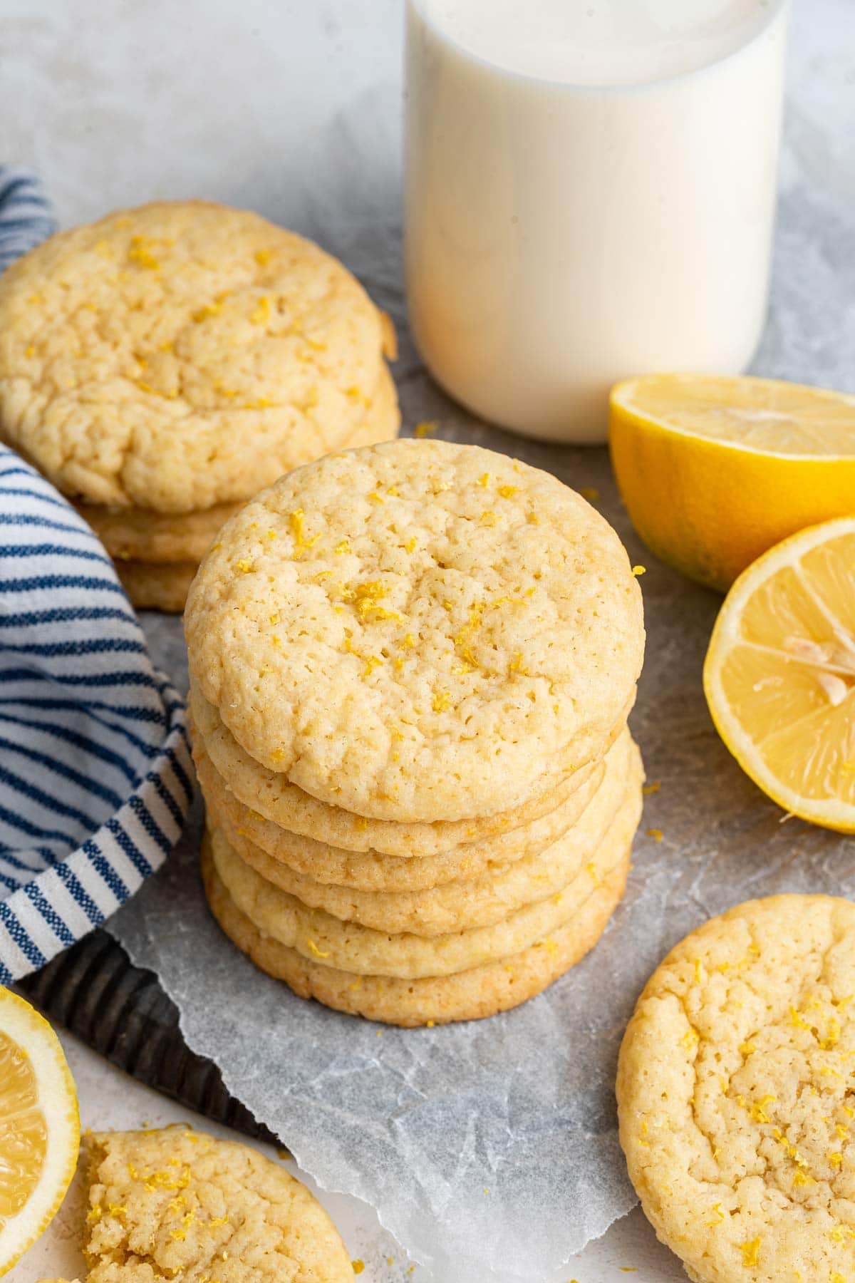 side view of a stack of lemon sugar cookies sprinkled with lemon zest