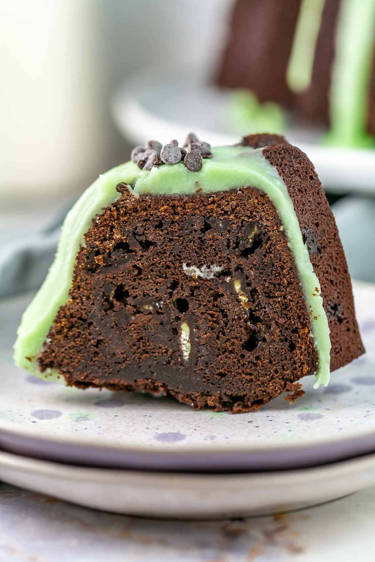 Slice of mint chocolate chip bundt cake on a plate.