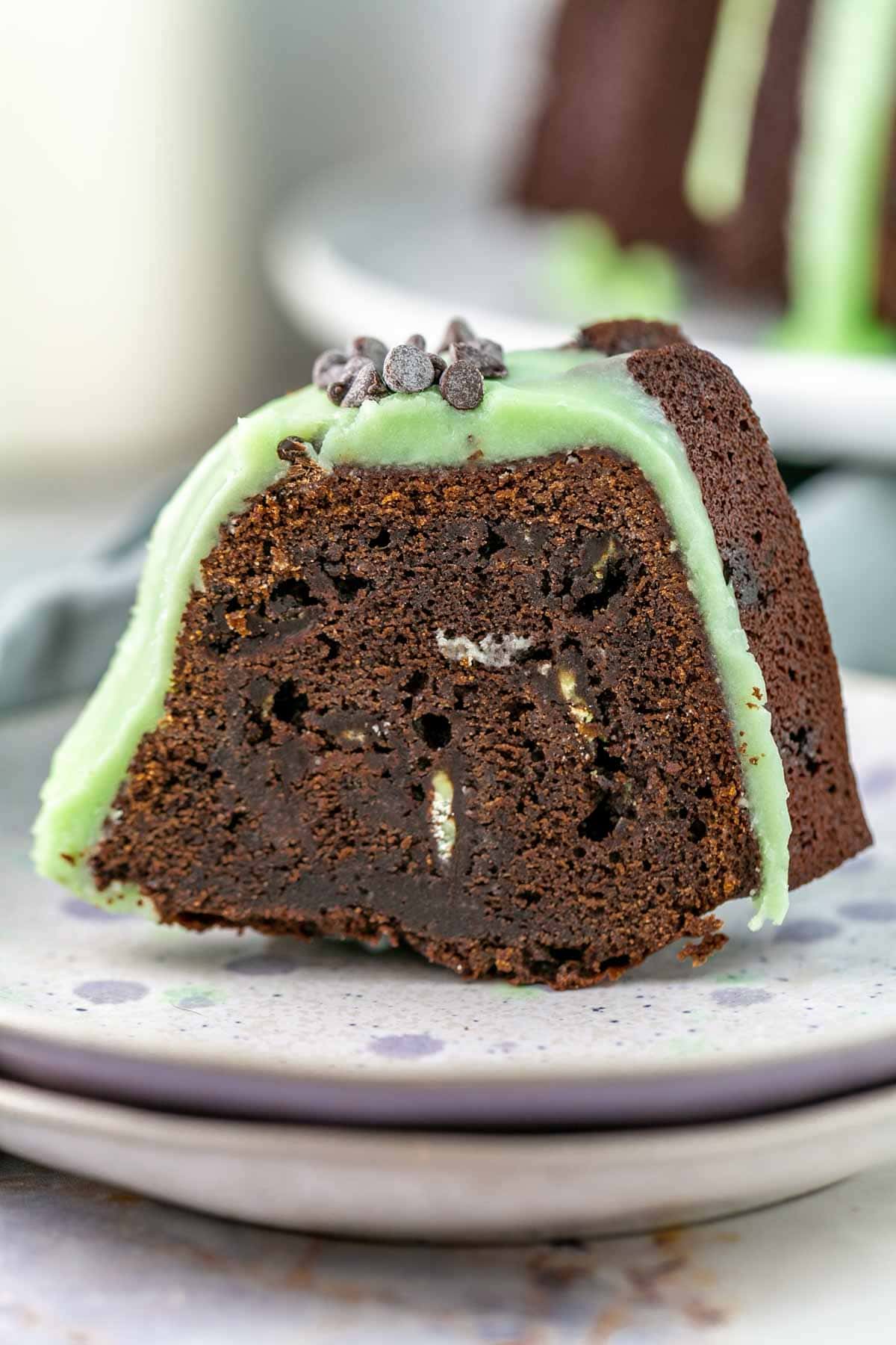 Slice of mint chocolate chip bundt cake on a plate. 