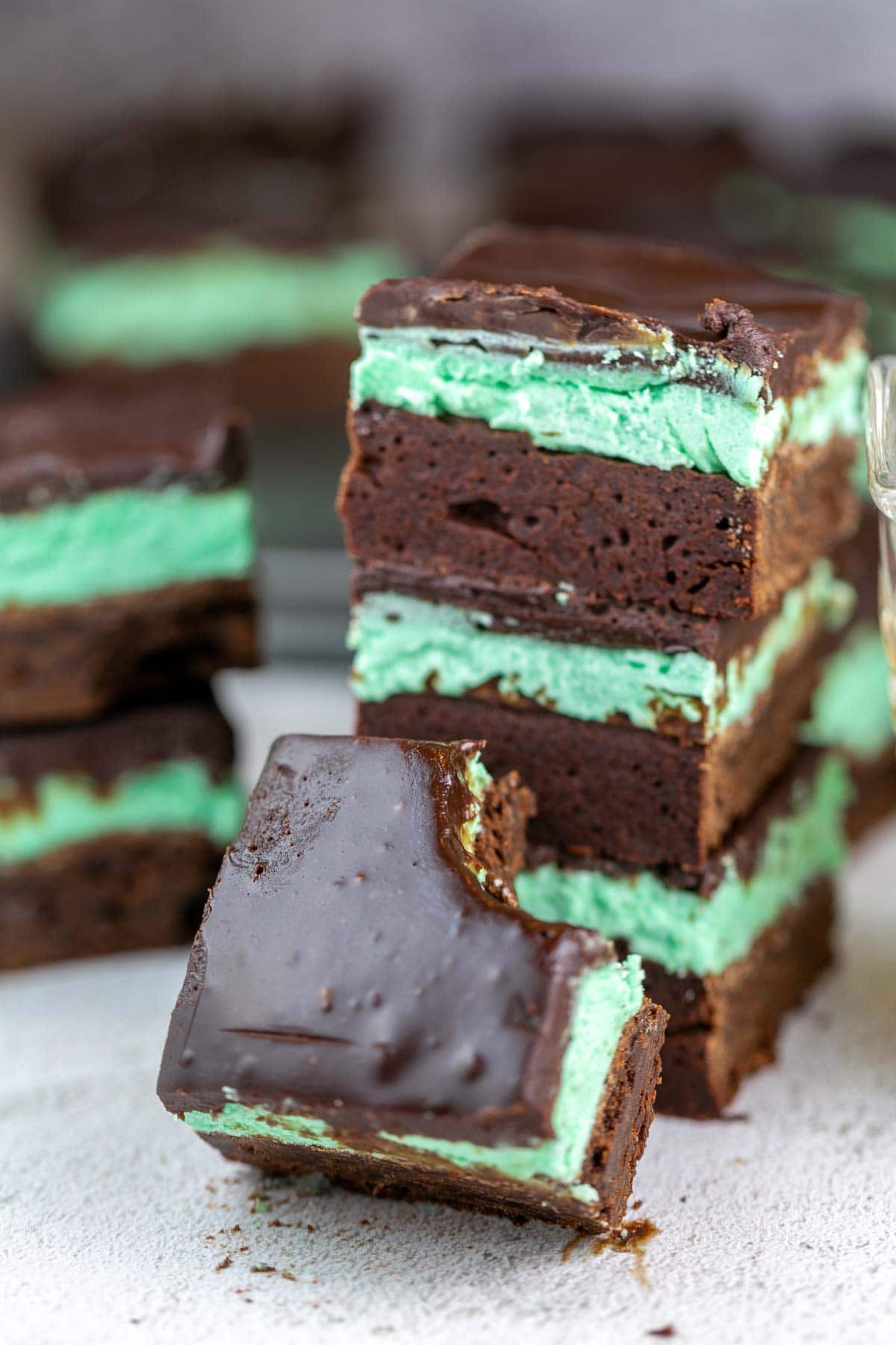 a three layer mint irish cream brownie with a bite taken out of it