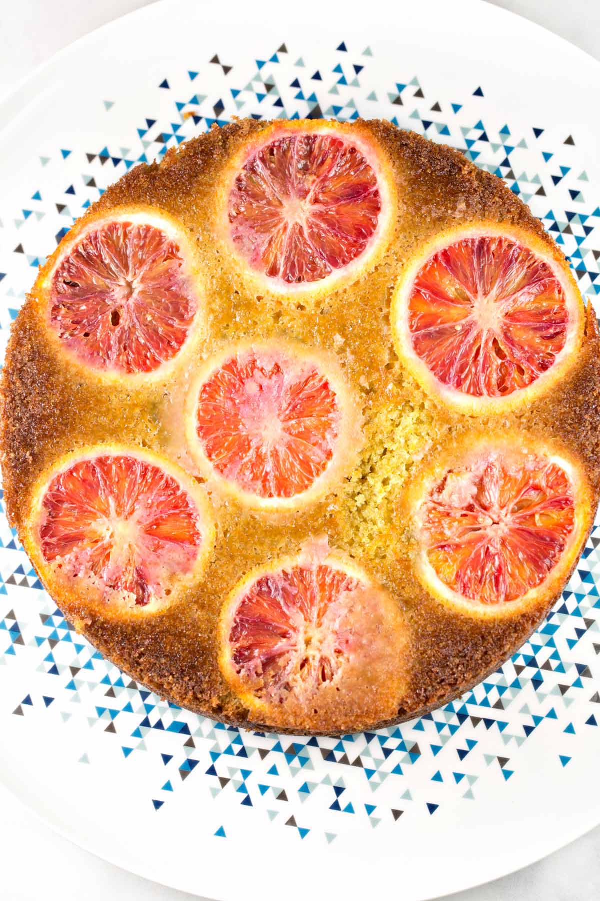olive oil cake covered with rounds of blood oranges
