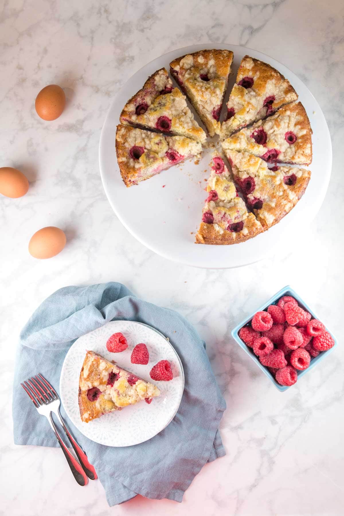 raspberry buttermilk coffee cake sliced into wedges