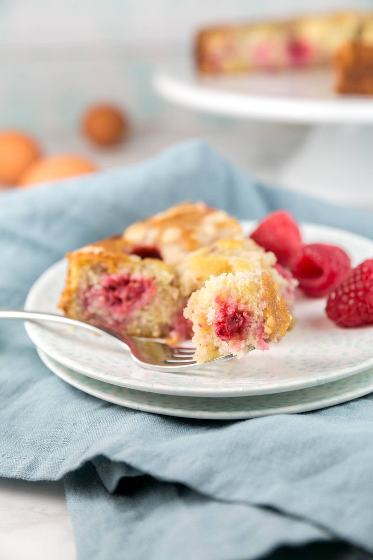 side view of a crumb coffee cake filled with raspberries