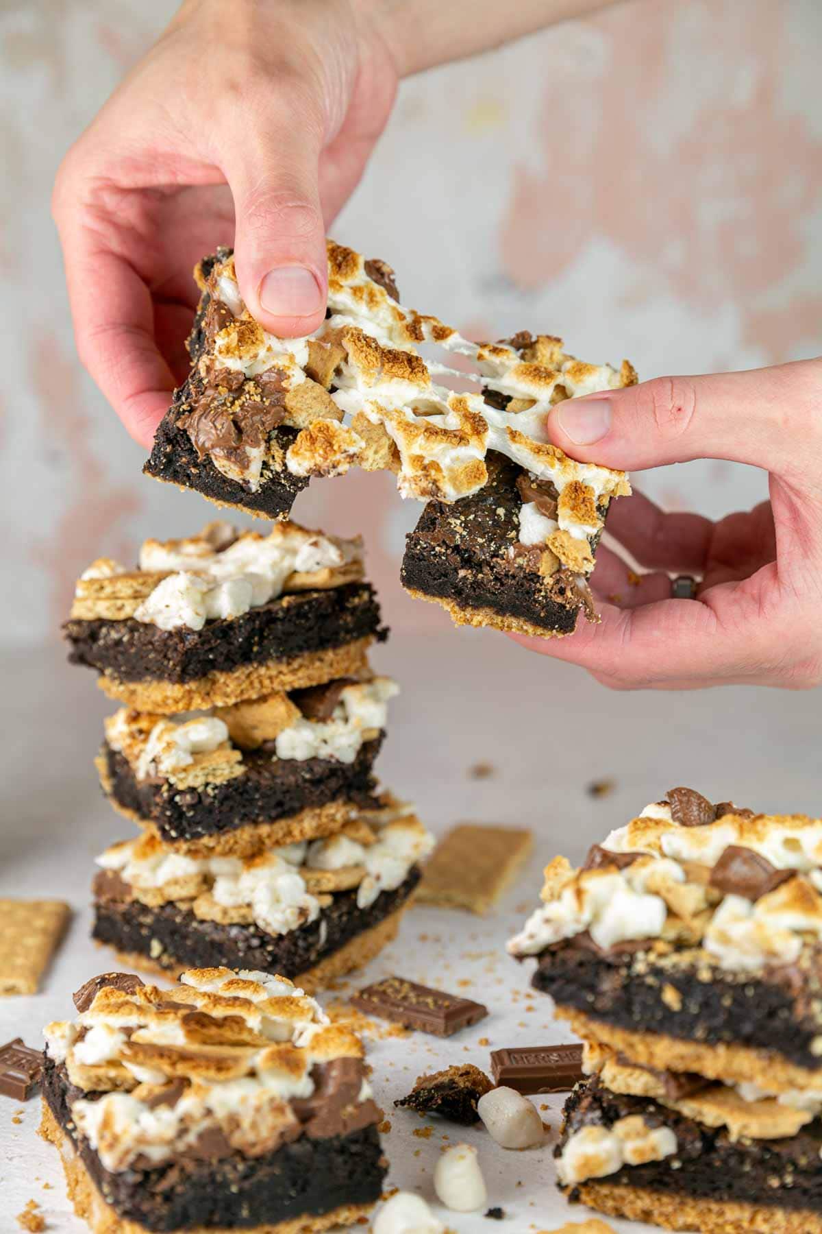 a smores brownie being pulled apart highlighting the gooey marshmallow