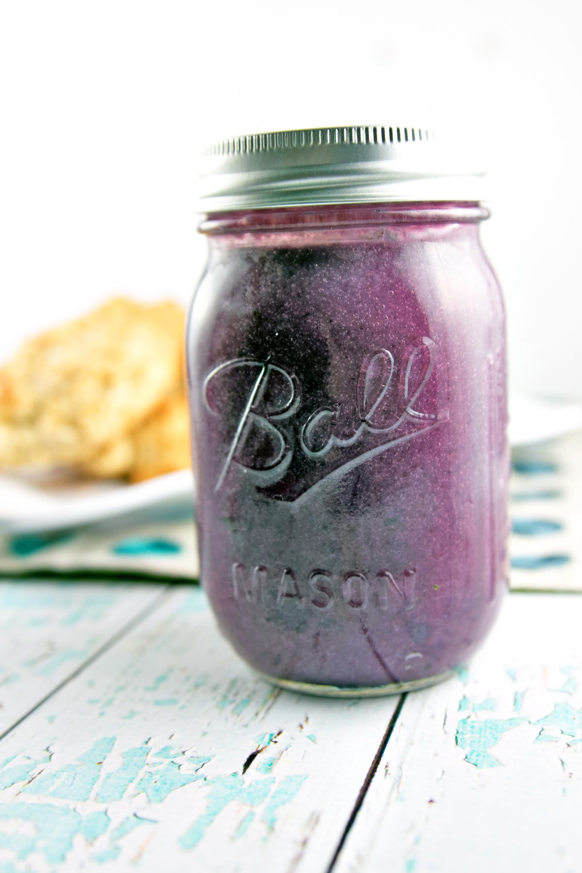 mason jar filled with vibrantly purple blueberry cardamom curd