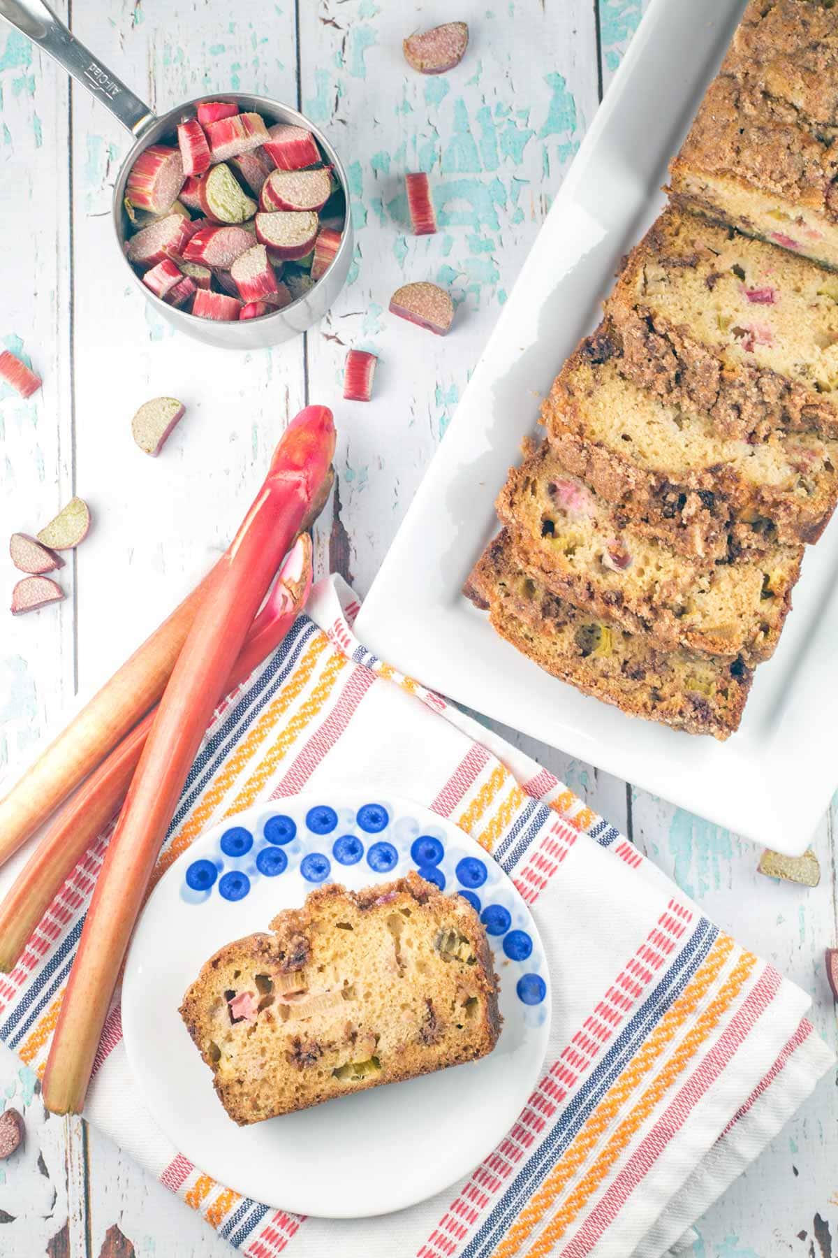 overhead view of a rhubarb bread with fresh rhubarb in the background