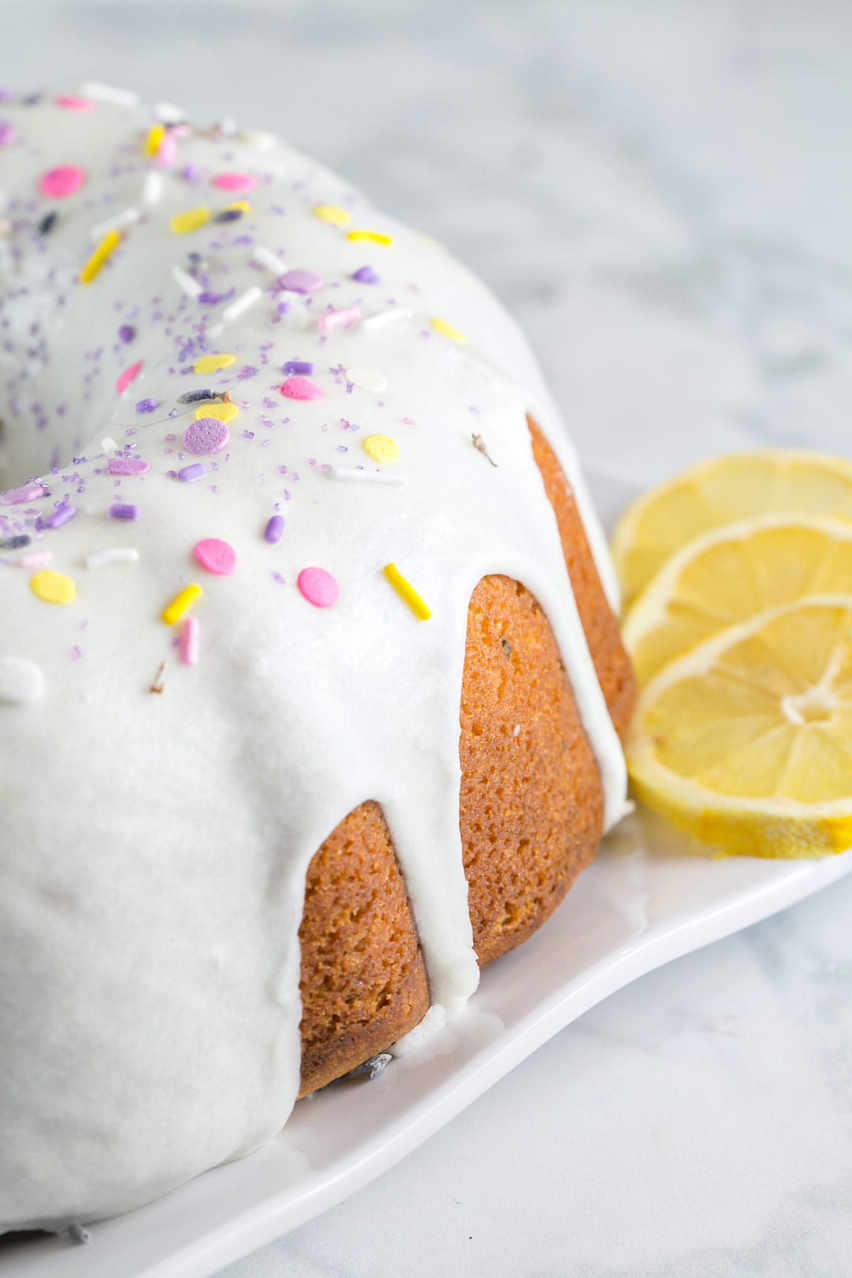 bright white glaze running down the side of a bundt cake