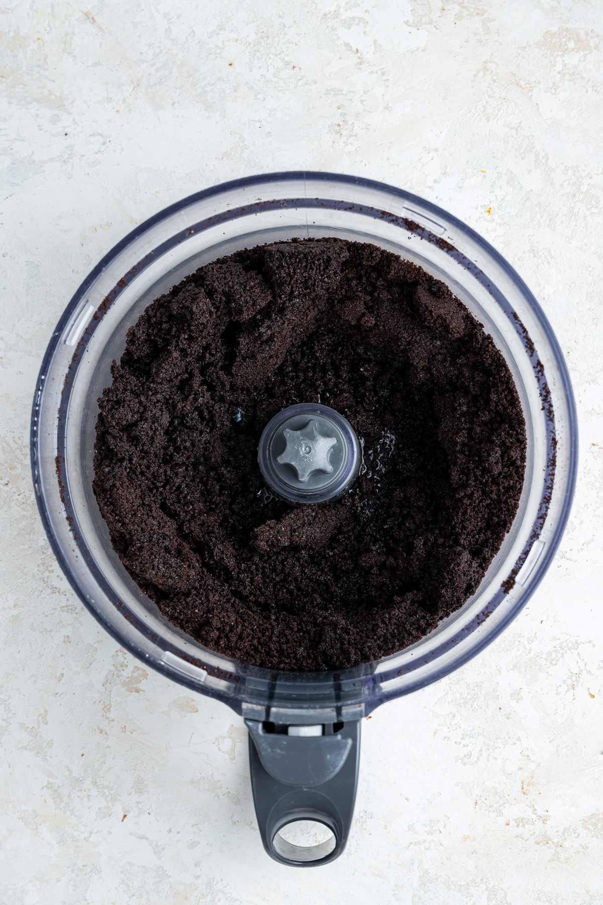 oreo cookies ground to crumbs inside a food processor