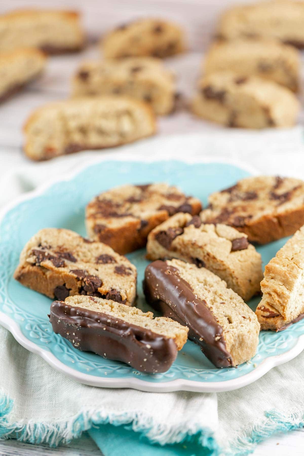 a pile of chocolate chip and chocolate dipped almond mandelbrot