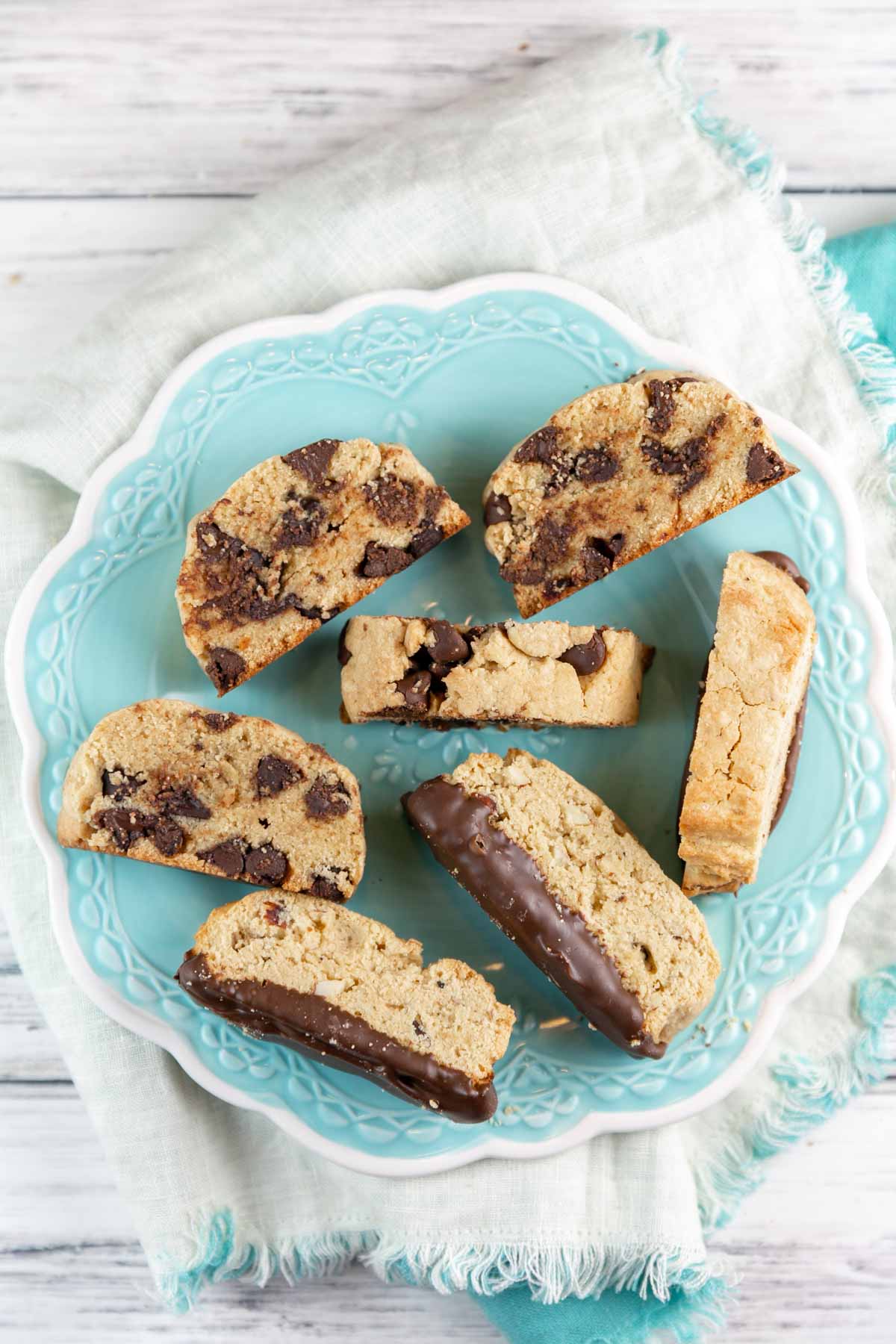 chocolate chip and chocolate dipped almond passover mandelbrot on a blue dessert plate