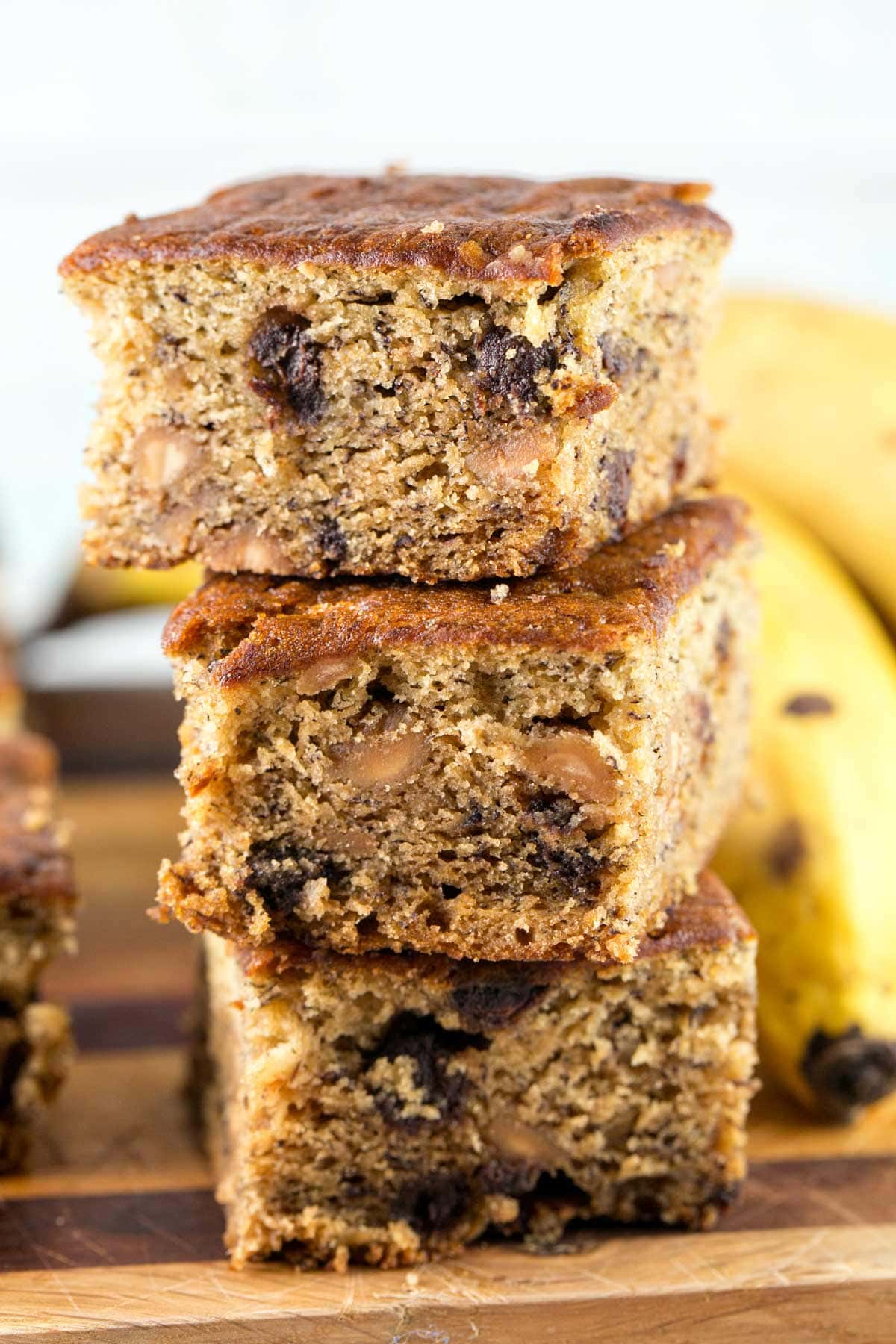 three vertically stacked banana bars full of chocolate and peanut butter chips