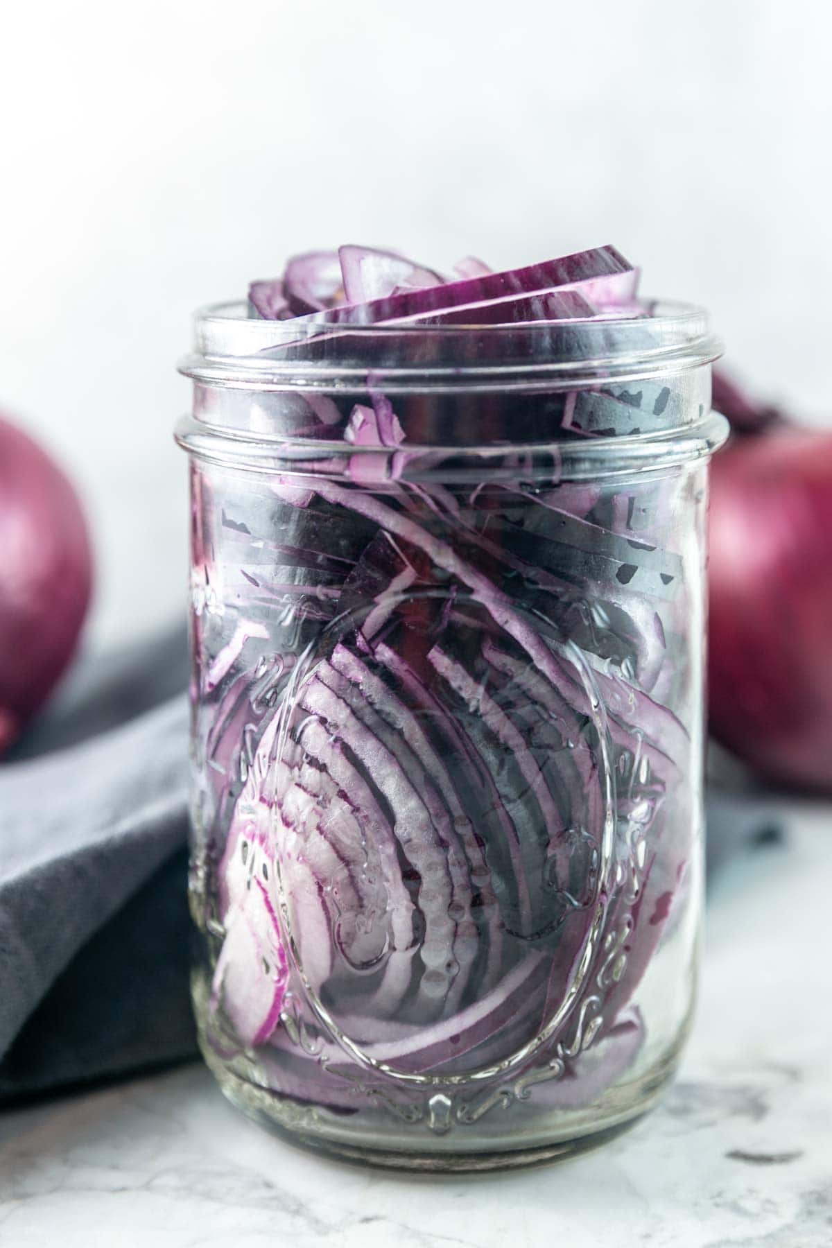 mason jar filled with thin slices of raw red onion