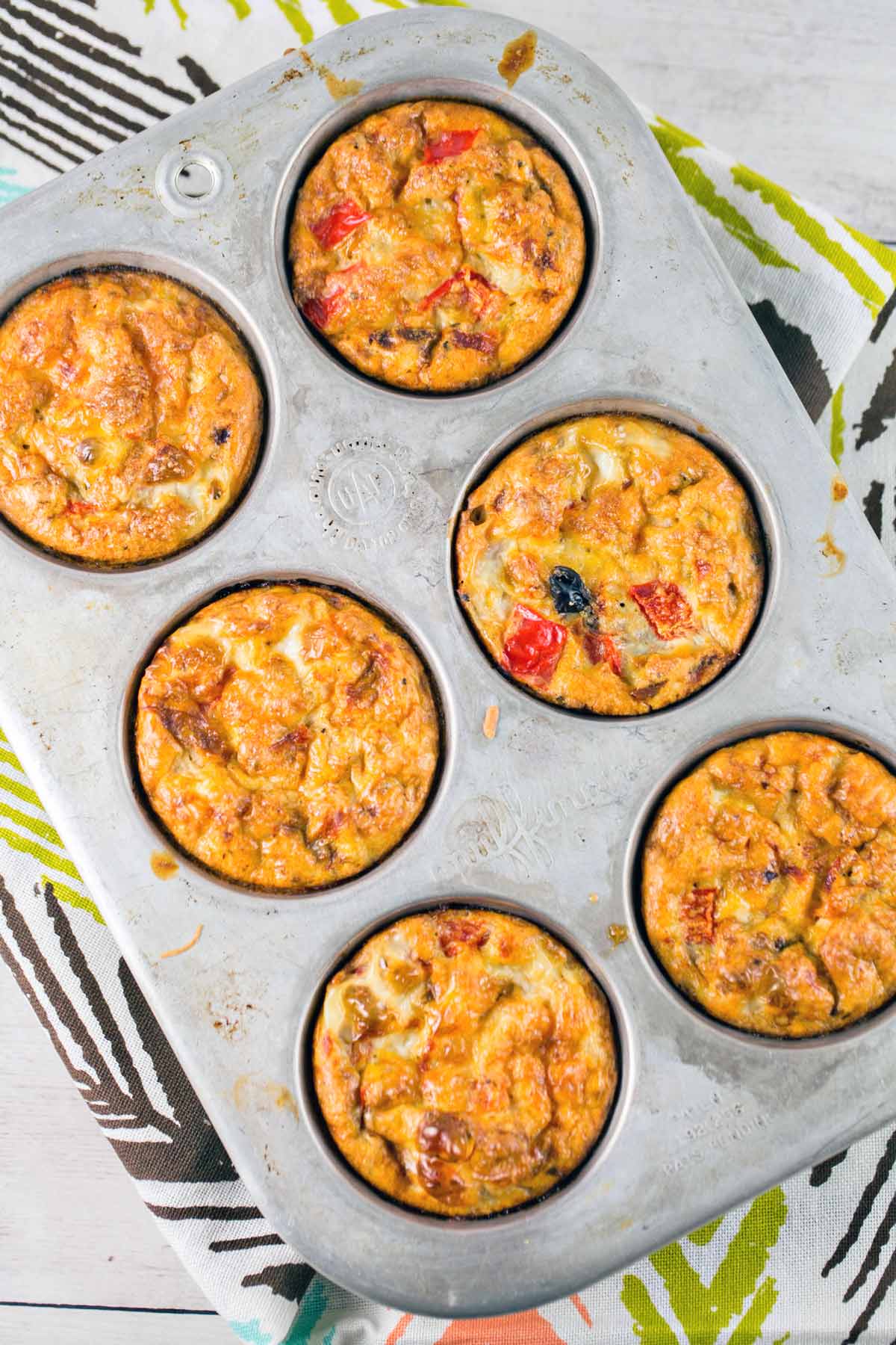 six baked egg muffins still in the muffin tin