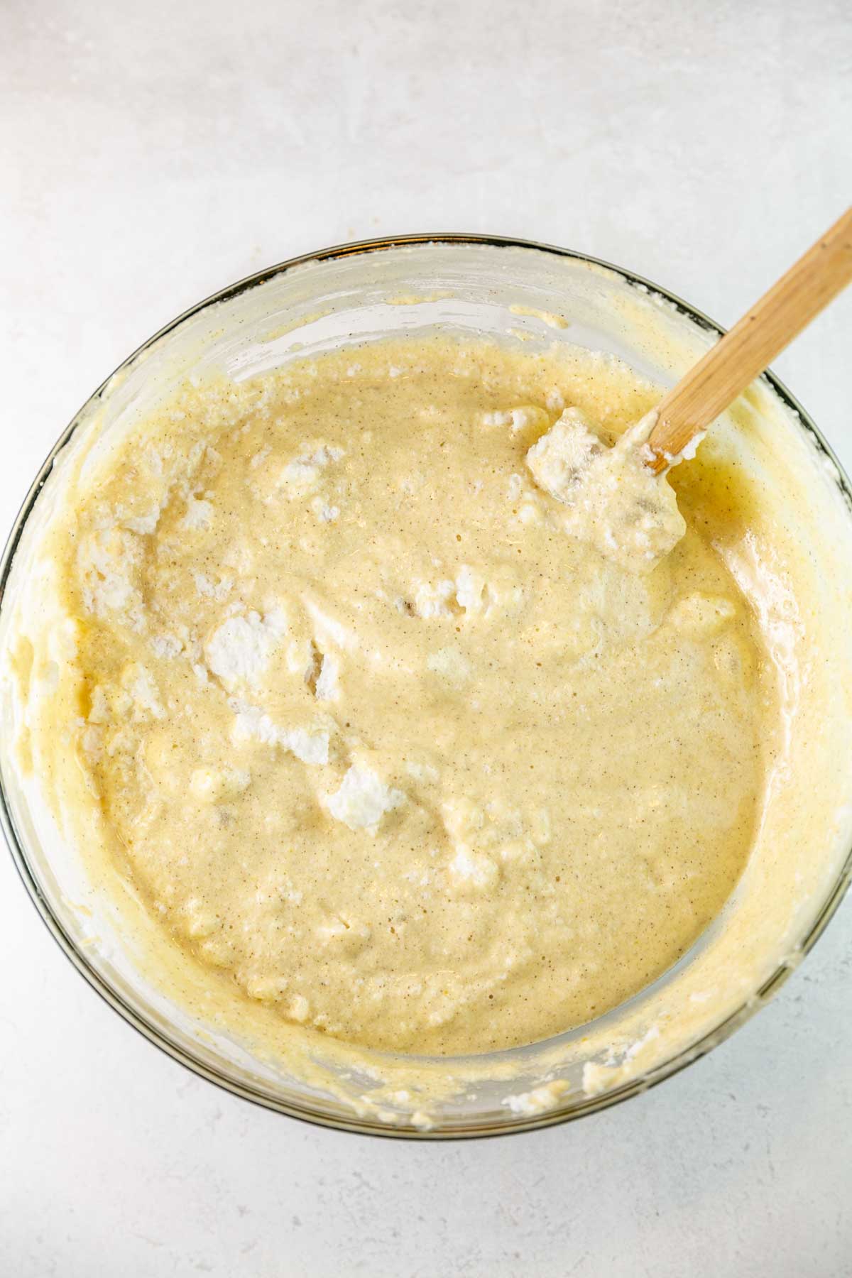gently folding whipped egg whites into a bowl of cake batter