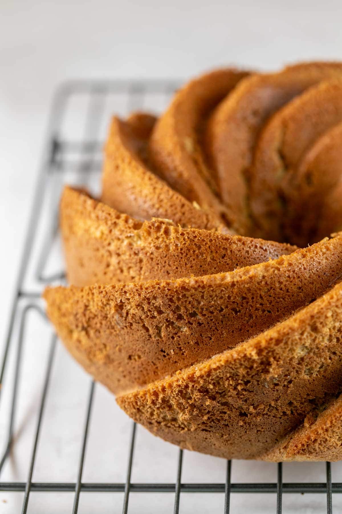 sponge cake bundt cake on a cooling rack